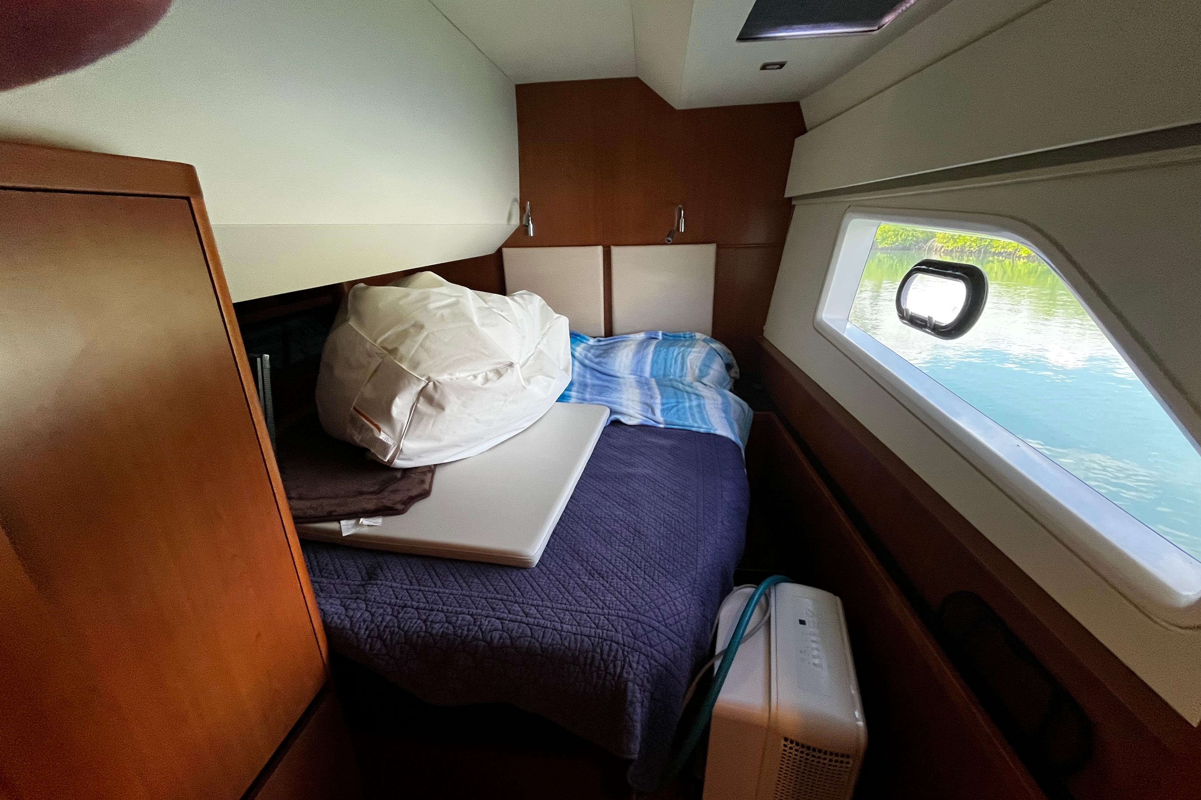 Cozy cabin interior of 2016 Aquila 44 yacht with bed and window view.