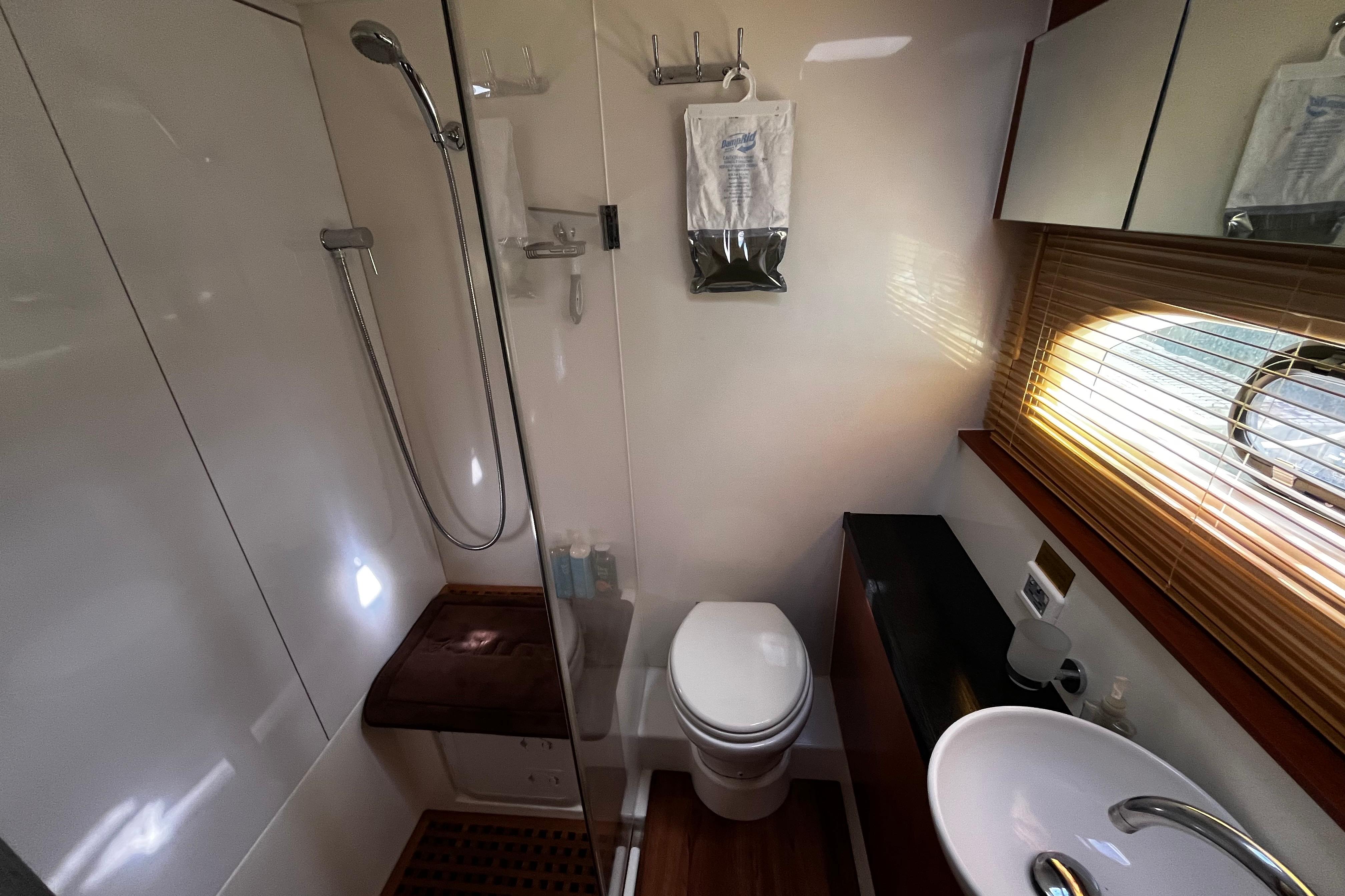 Bathroom interior of 2016 Aquila 44 yacht with shower, toilet, and sink.
