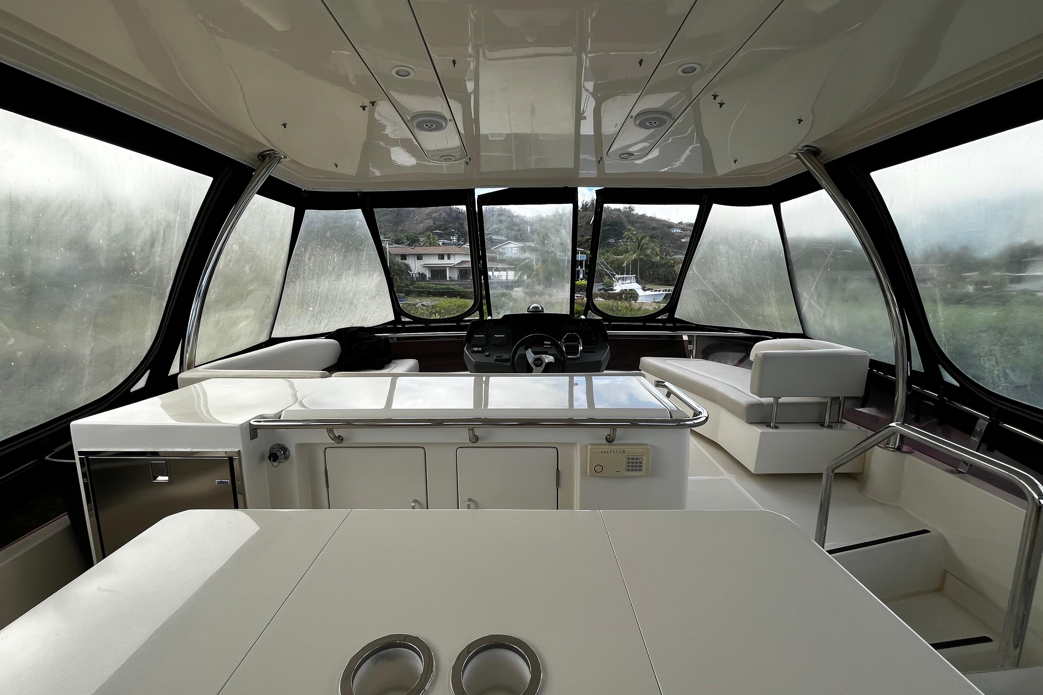 Interior of a 2016 Aquila 44 yacht with modern seating and panoramic windows.