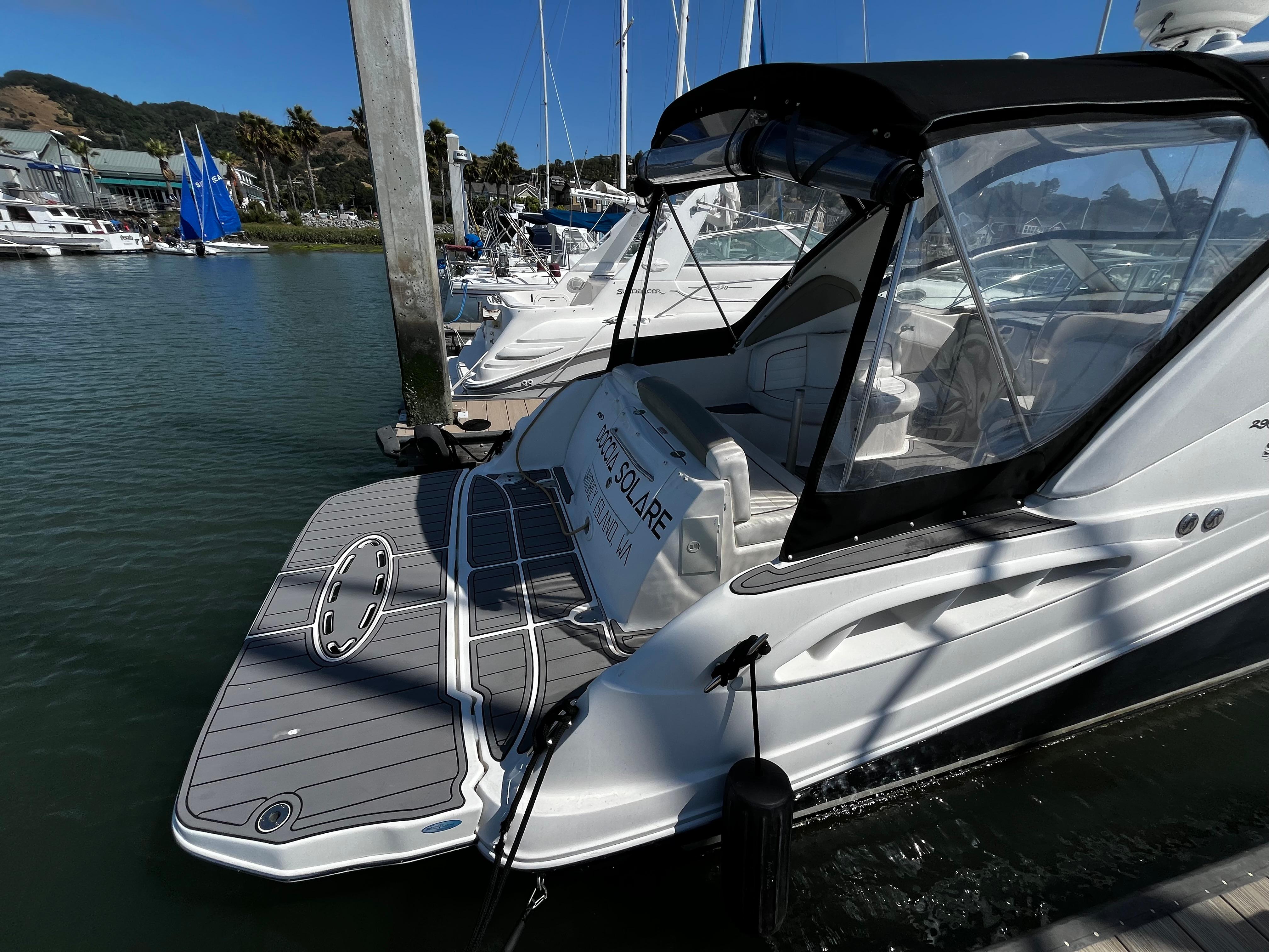 2006 Sea Ray 290 Sundancer docked at marina, featuring sleek design and spacious deck.