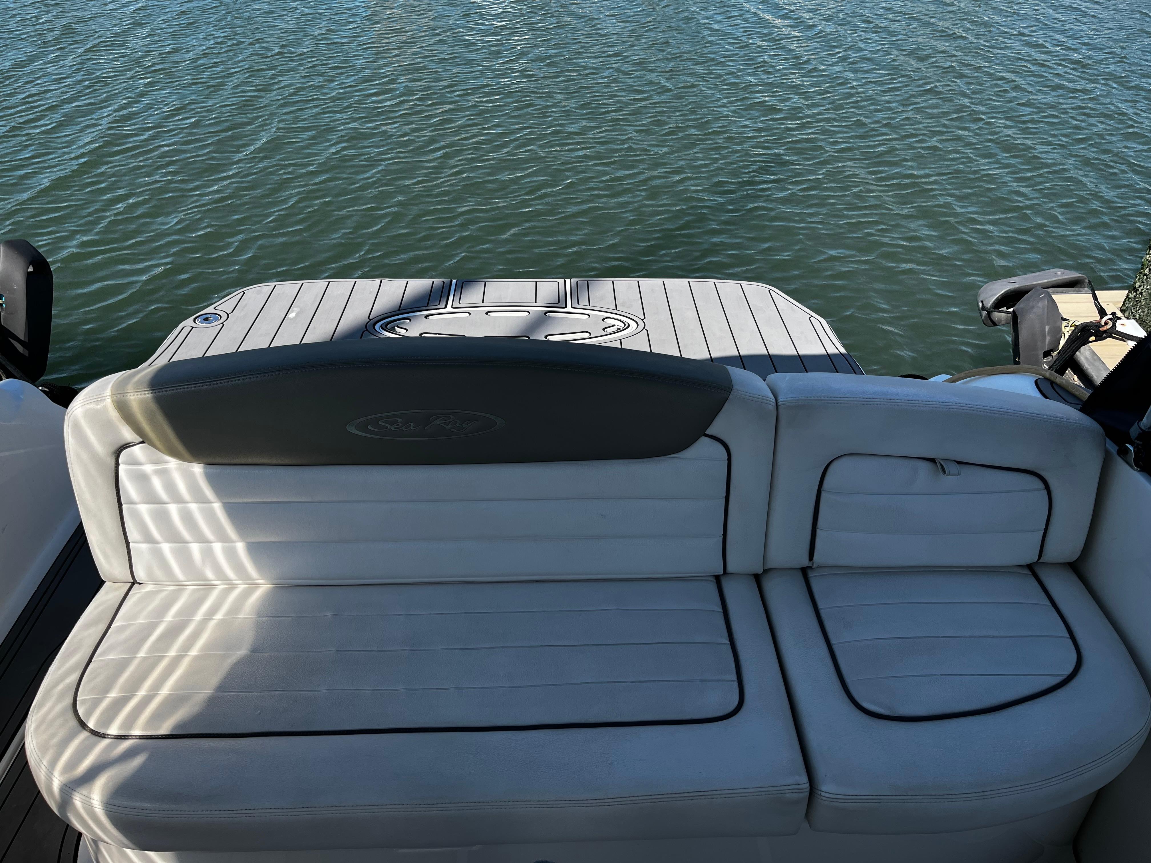 2006 Sea Ray 290 Sundancer boat with white seating and water view.