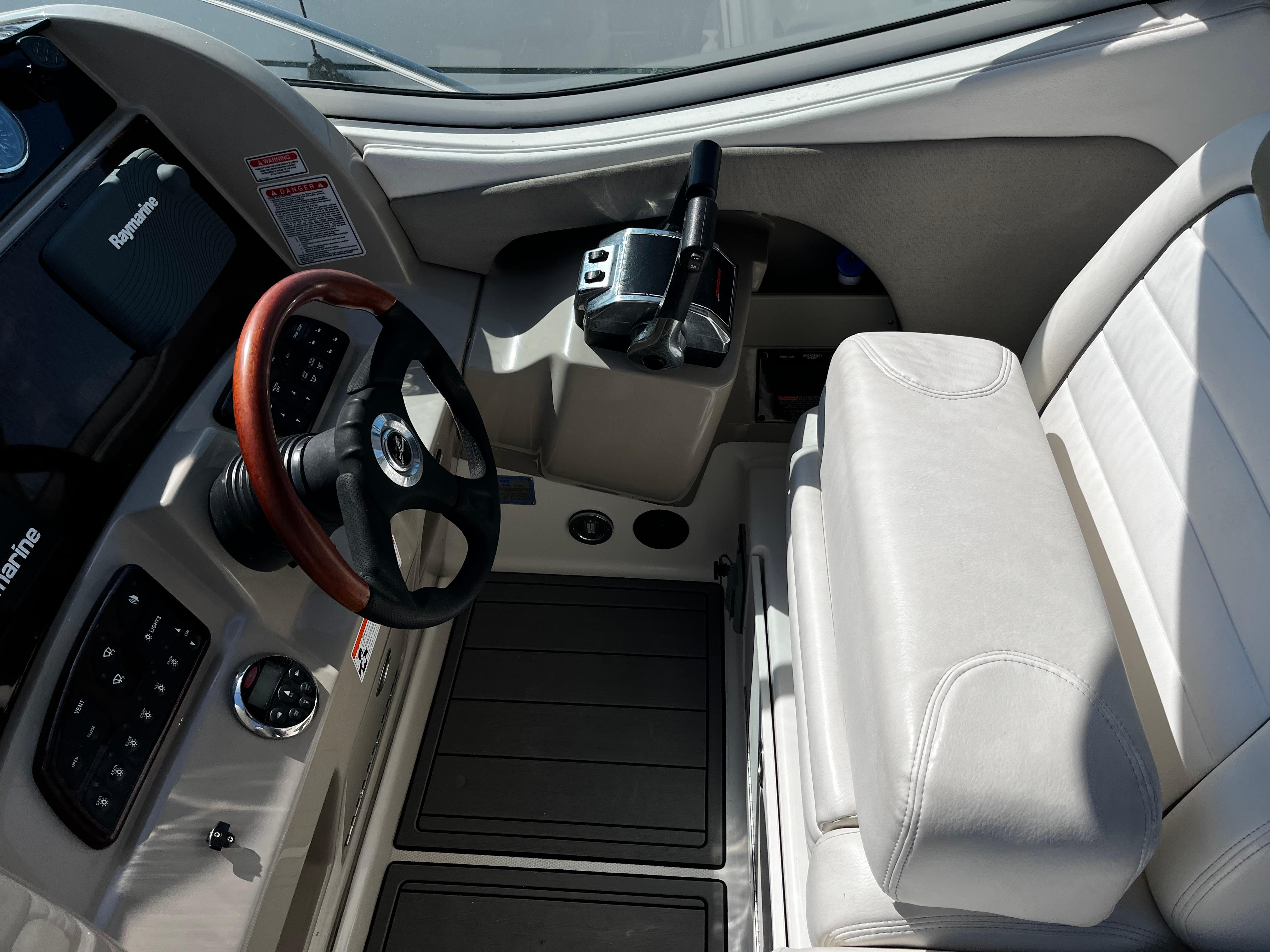 2006 Sea Ray 290 Sundancer helm with steering wheel and control panel.