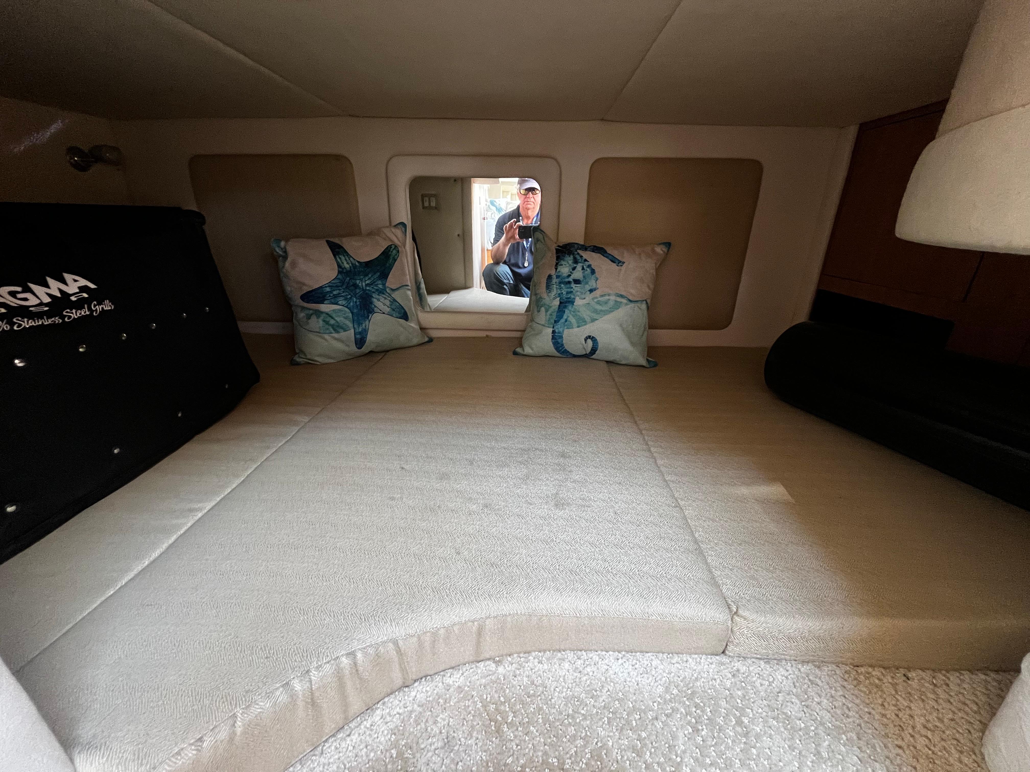 Interior cabin of 2006 Sea Ray 290 Sundancer with decorative pillows and cozy seating.