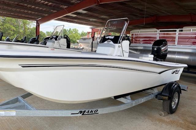 2026 Mako Pro Skiff 15 CC boat on trailer under shelter.