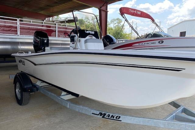 2026 Mako Pro Skiff 15 CC boat on trailer, under a covered area.