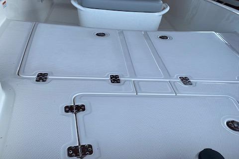 2026 Mako Pro Skiff 15 CC boat deck with storage compartments.