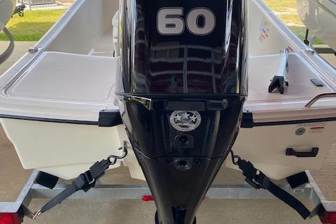 2026 Mako Pro Skiff 15 CC with 60 HP outboard motor, rear view.