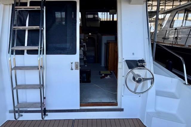 1989 Mediterranean 38 yacht with ladder and open cabin door, showcasing interior.