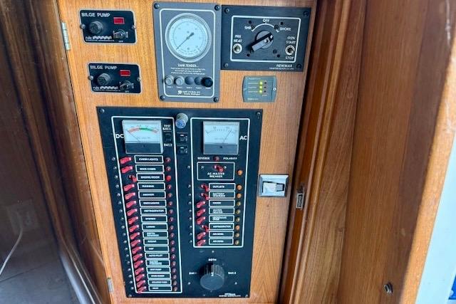 Electrical control panel on a 1989 Mediterranean 38 boat, featuring switches and gauges.