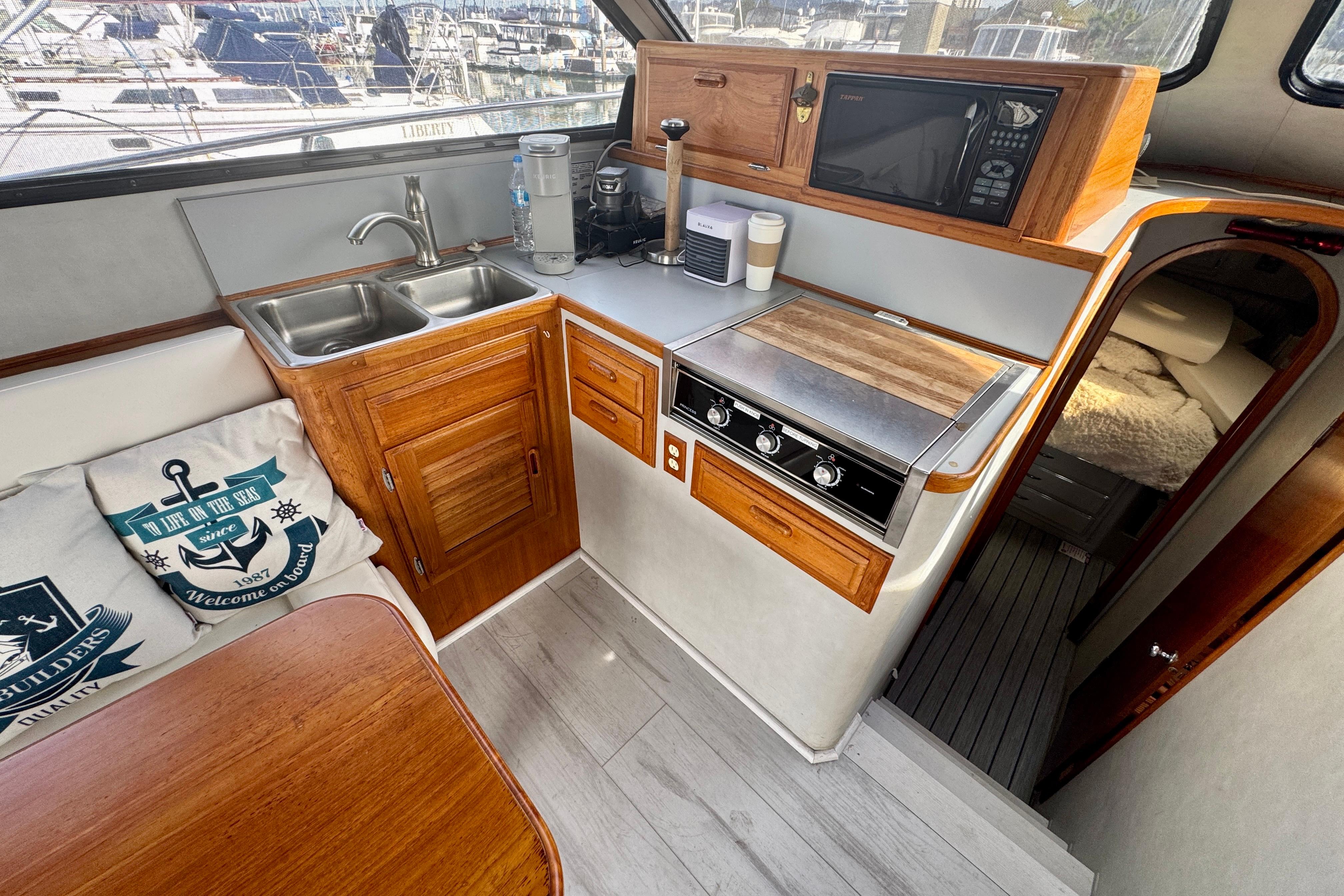 Cozy 1989 Mediterranean 38 yacht kitchen with wooden cabinetry and modern appliances.