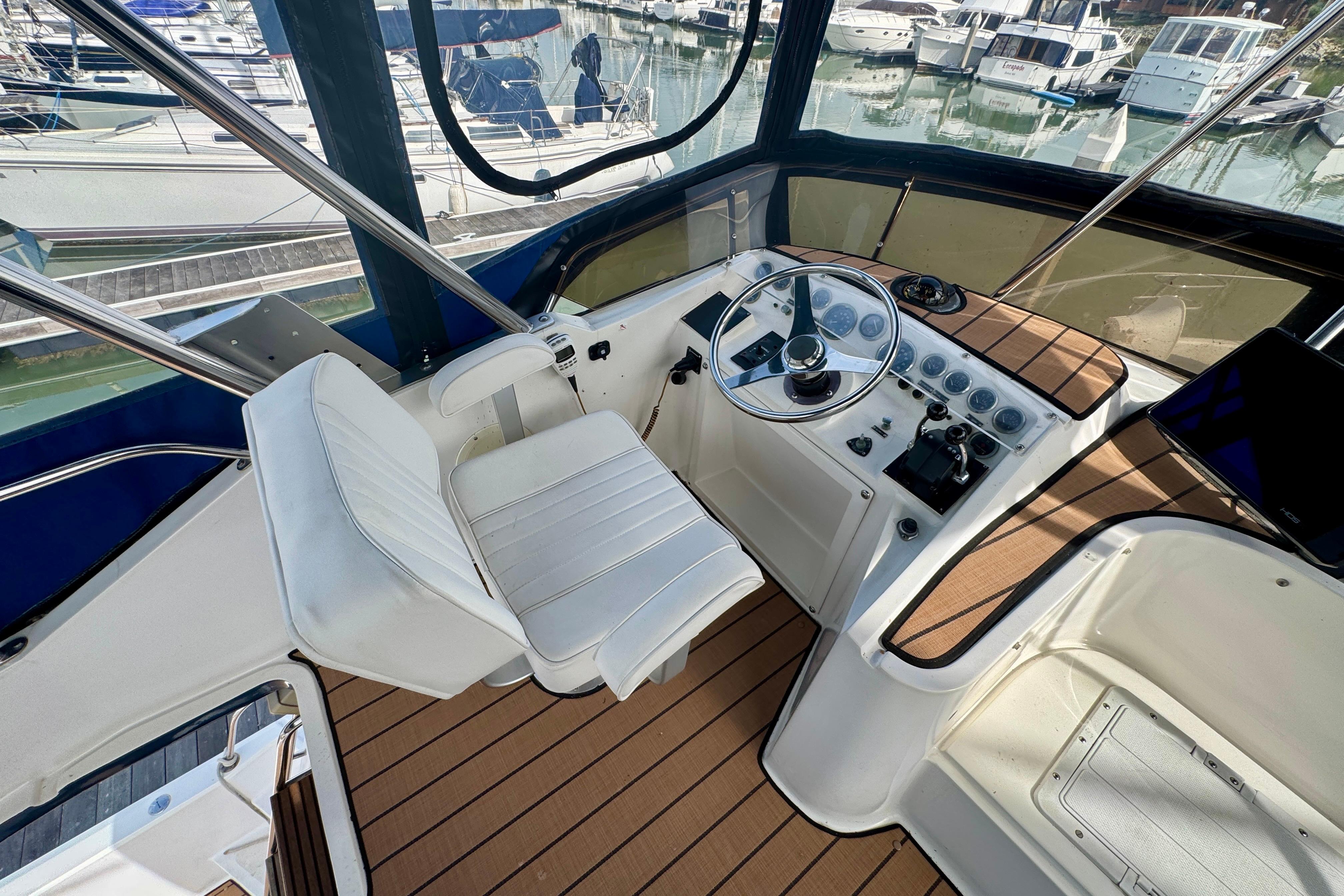 Cockpit of 1989 Mediterranean 38 yacht with steering wheel and control panel.