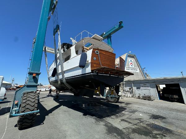 Grand Alaskan Raised Pilothouse 1977 yacht in dry dock at a marina.