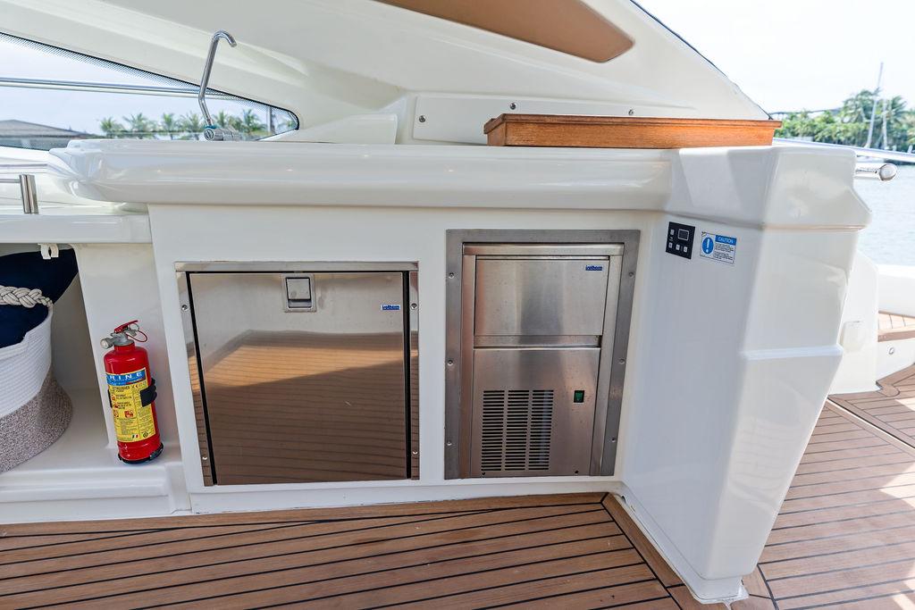 Cranchi-56 HT 2014-Minion FL-US-Outdoor kitchen area on 2014 Cranchi 56 HT yacht with stainless steel appliances and fire extinguisher.-9819548 | Thumbnail