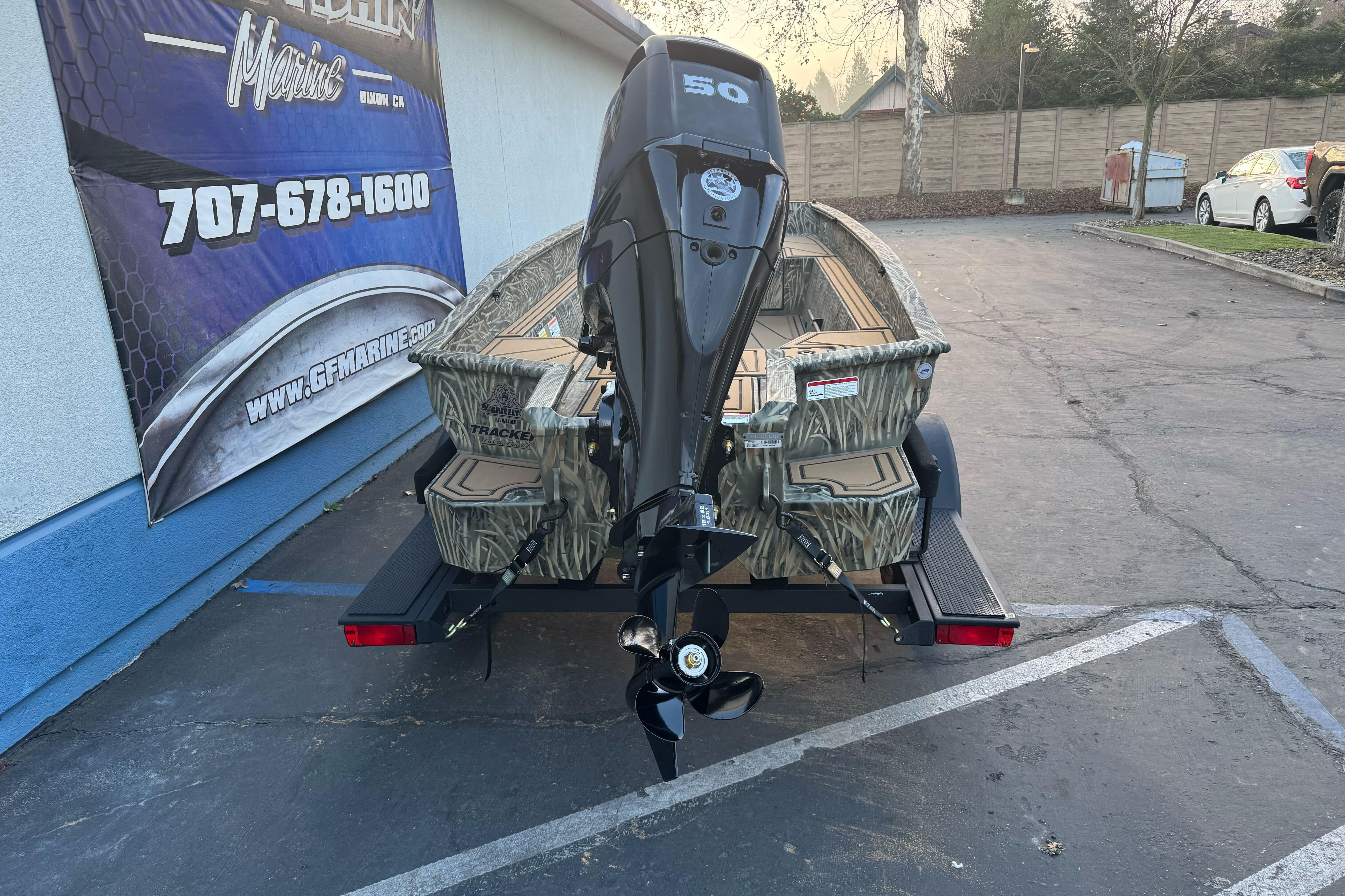2026 Tracker Grizzly 1650 T Prairie Wings Edition boat on trailer, rear view.