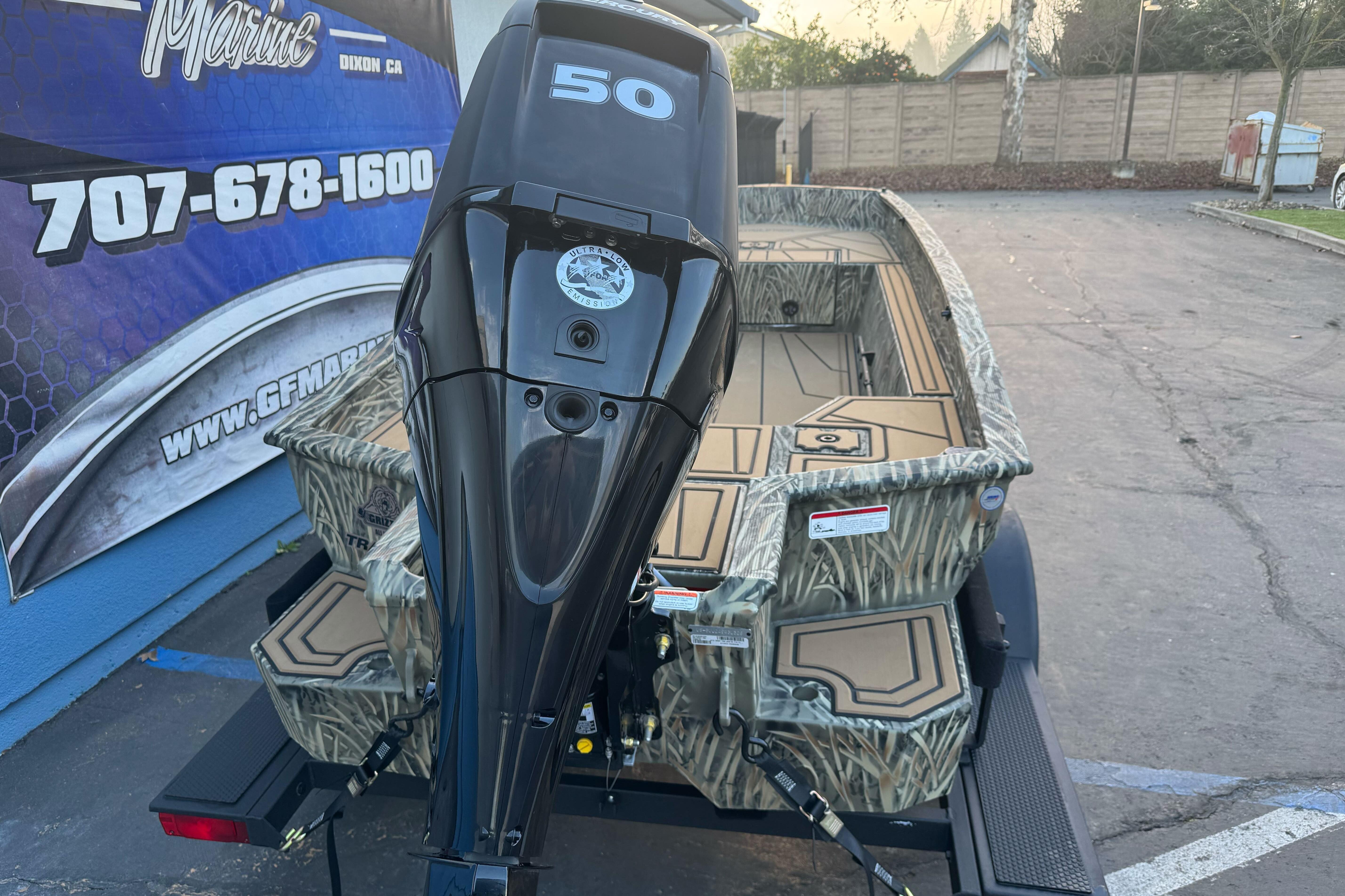 2026 Tracker Grizzly 1650 T Prairie Wings Edition boat with powerful outboard motor.