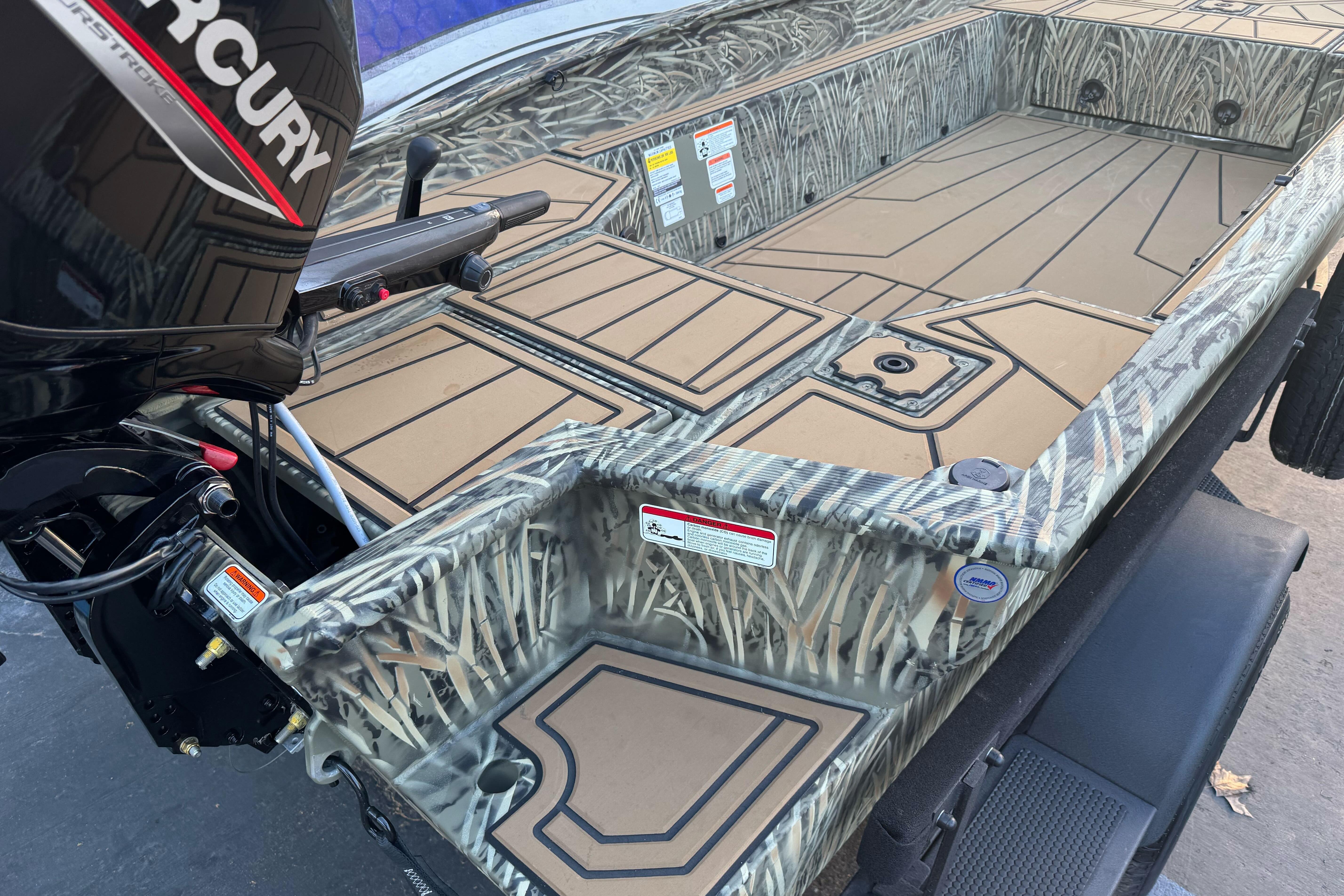 2026 Tracker Grizzly 1650 T Prairie Wings Edition boat with camo design and Mercury engine.