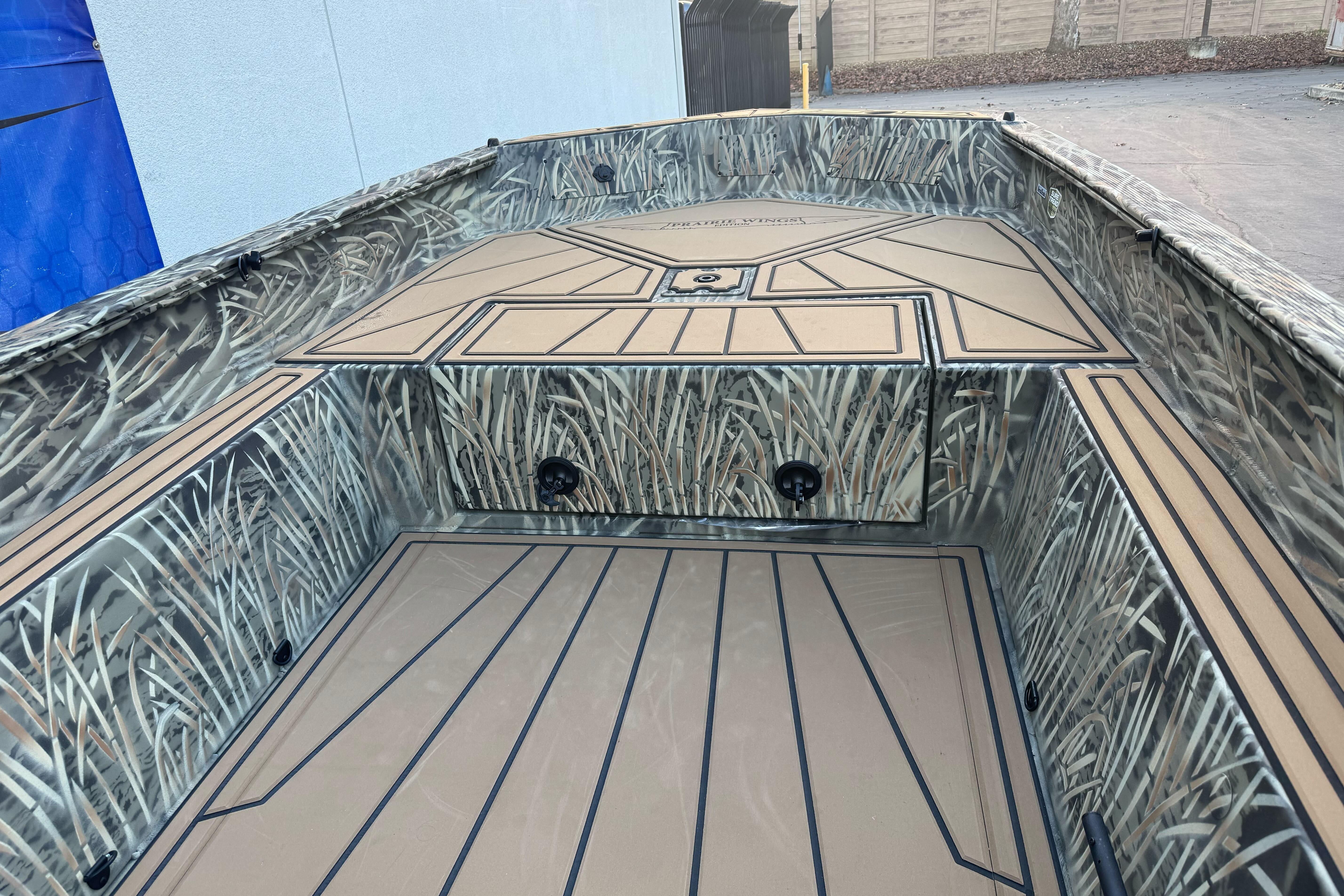 2026 Tracker Grizzly 1650 T Prairie Wings Edition boat with camo interior design.