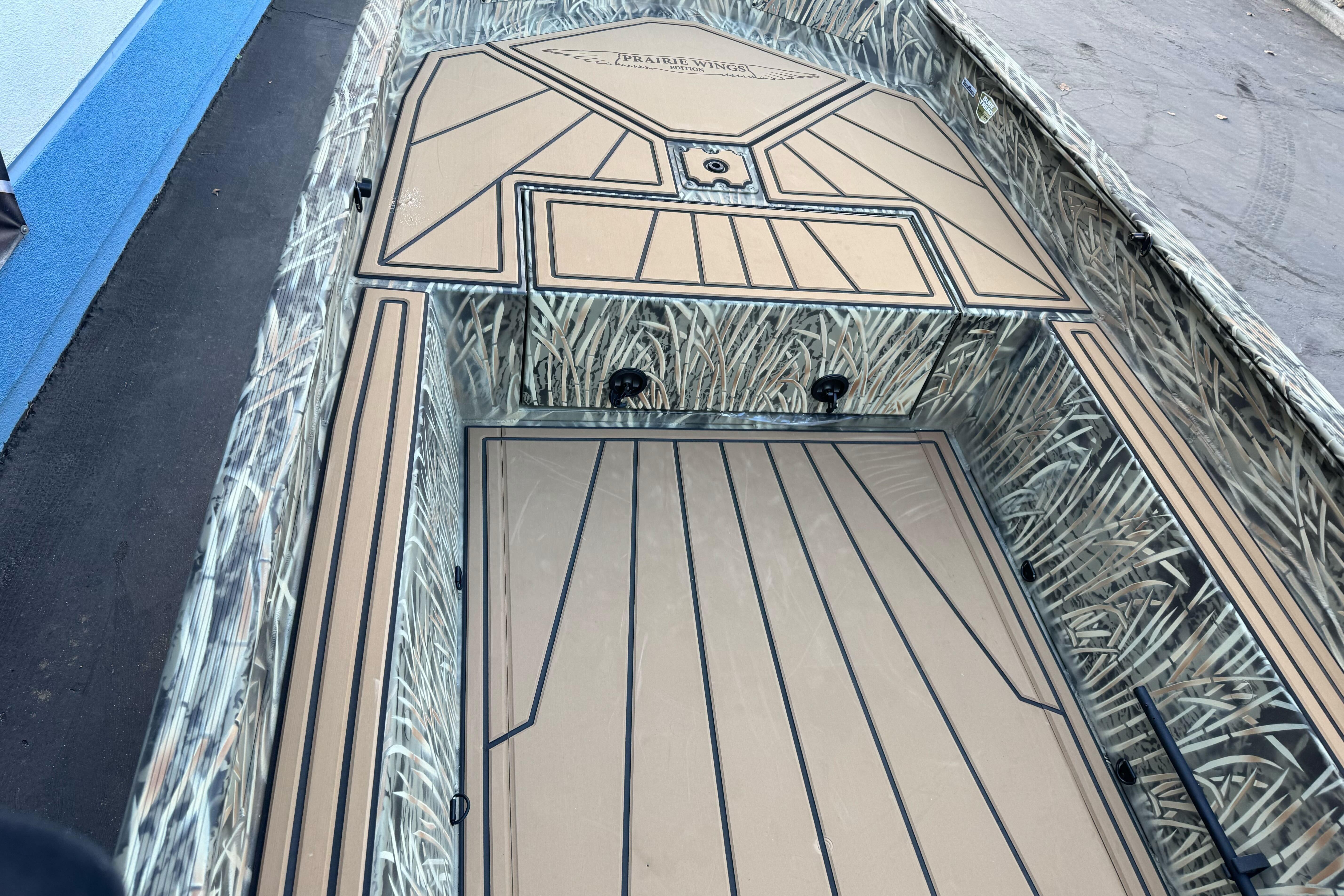 2026 Tracker Grizzly 1650 T Prairie Wings Edition boat with camouflage interior design.