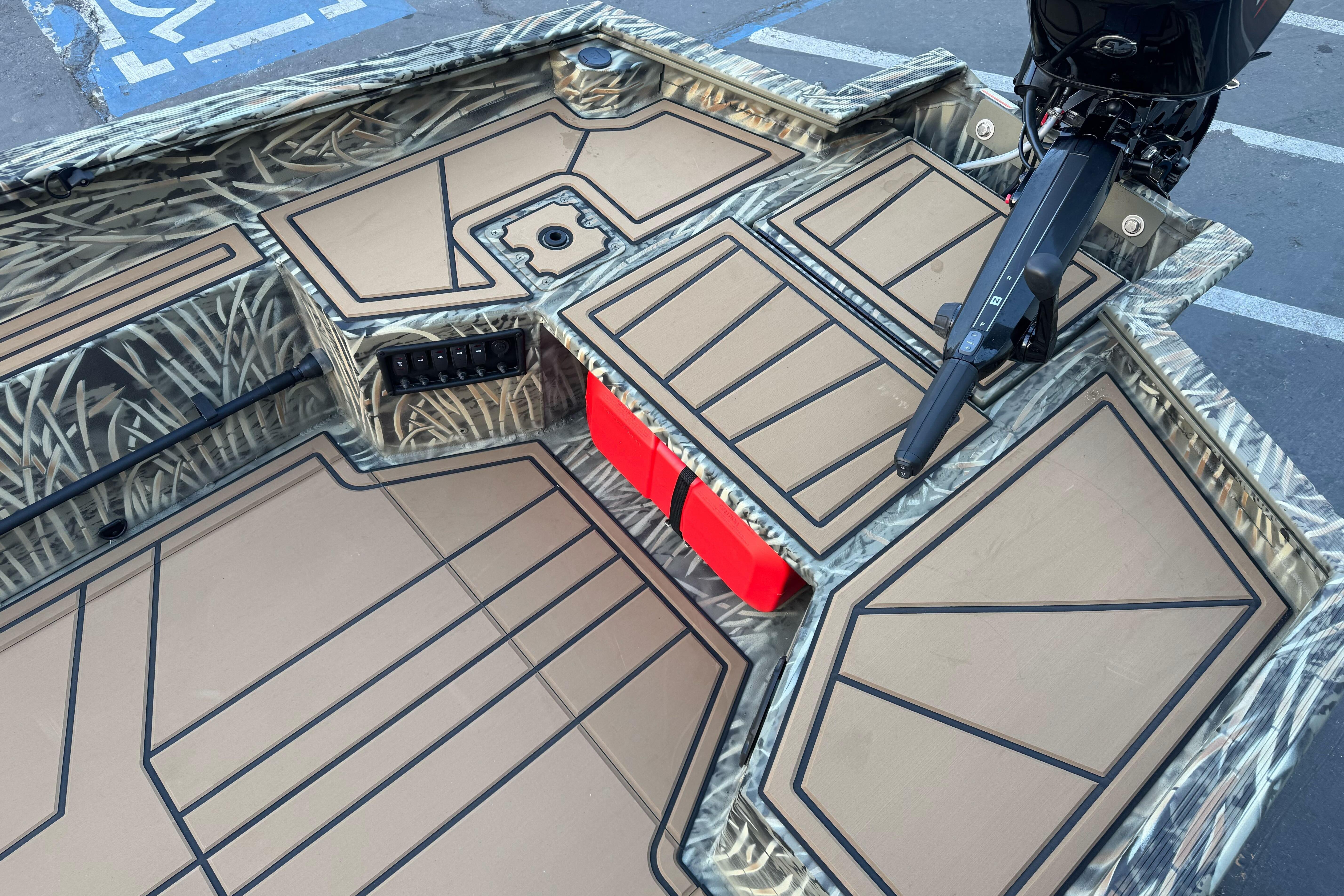 2026 Tracker Grizzly 1650 T Prairie Wings Edition boat interior with camouflage design and motor.