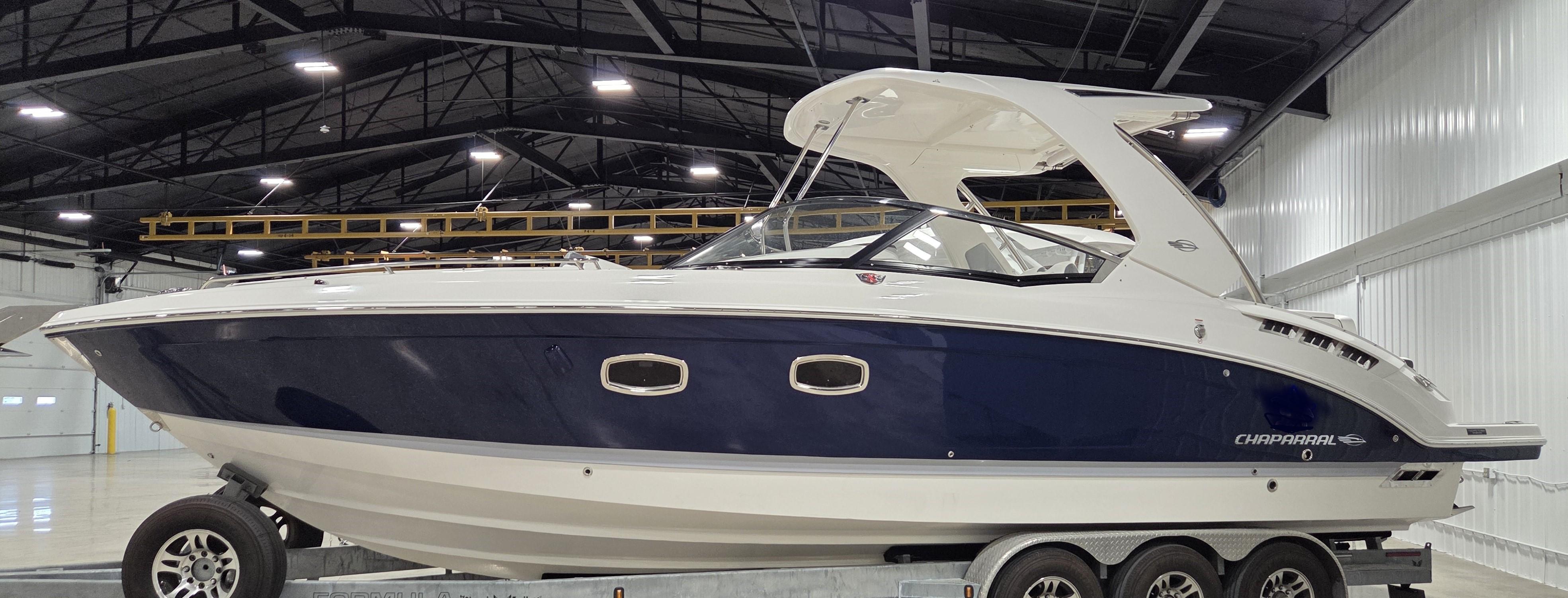 2022 Chaparral 347 SSX boat in a spacious indoor facility.