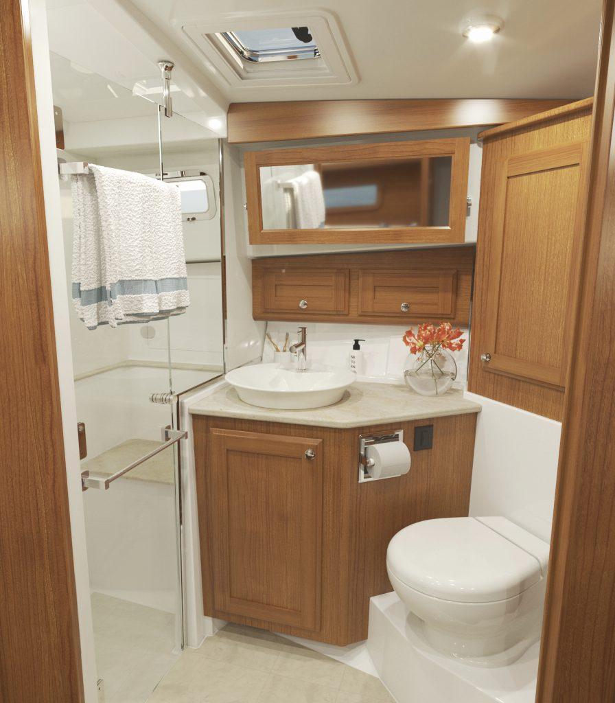 Luxurious bathroom in 2026 Sabre 43 Salon Express yacht with wood cabinetry and modern fixtures.