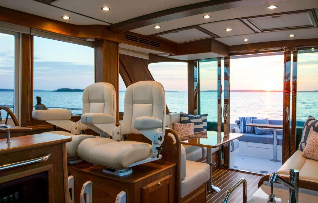 Luxurious interior of 2026 Sabre 43 Salon Express yacht with ocean view at sunset.