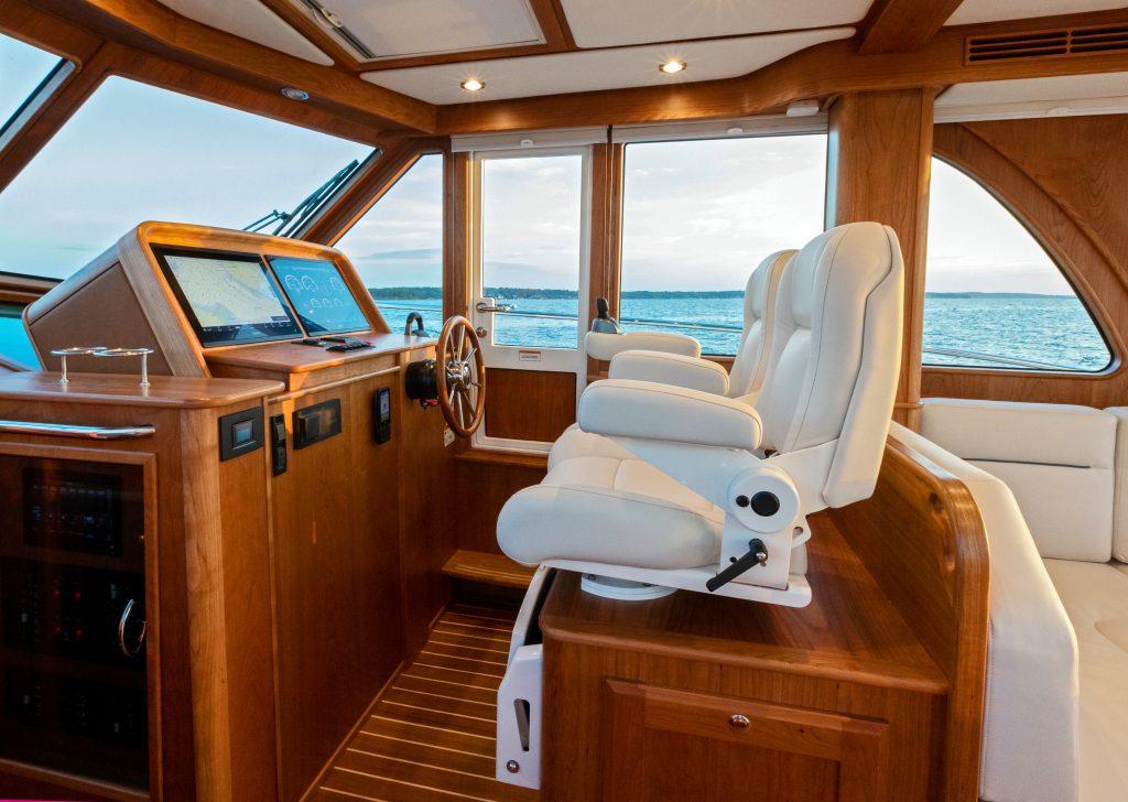 Interior of 2026 Sabre 43 Salon Express yacht with luxurious seating and navigation controls.