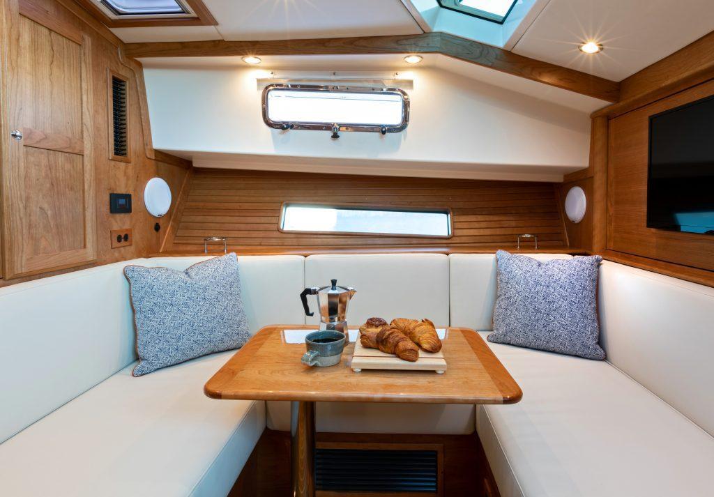 Luxurious interior of 2026 Sabre 43 Salon Express yacht with cozy seating and breakfast setup.