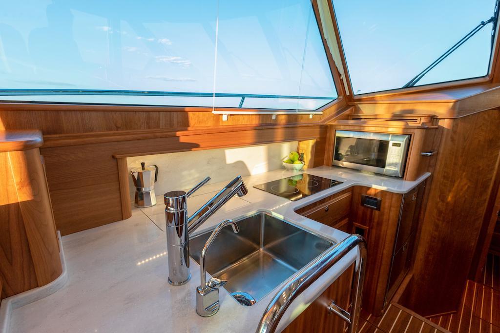 Luxurious kitchen interior of 2026 Sabre 43 Salon Express yacht with modern amenities.