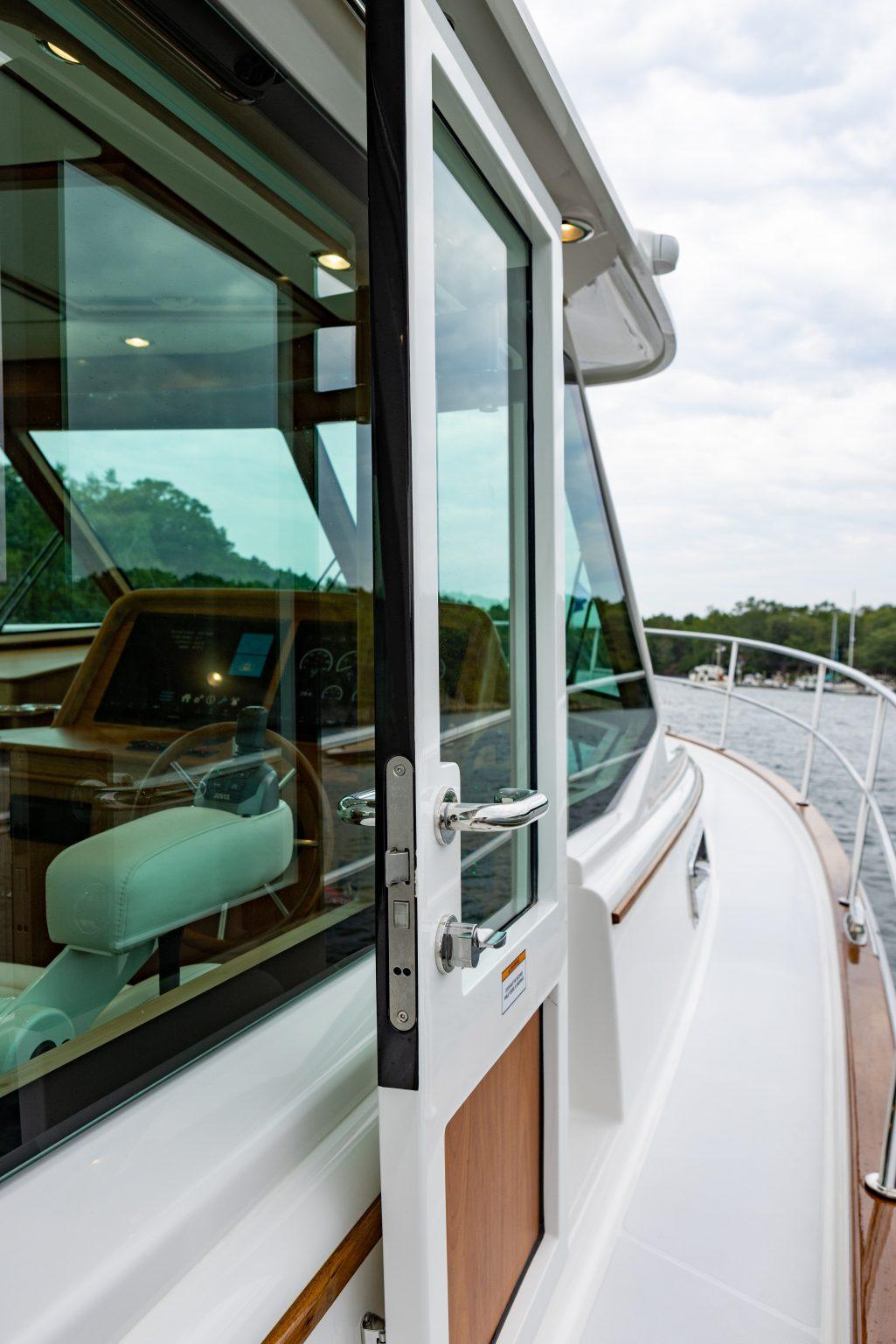 2026 Sabre 43 Salon Express yacht with open door, showcasing sleek design and luxurious interior.