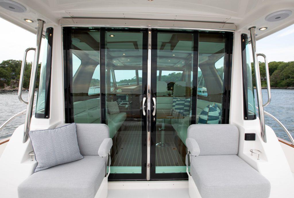 2026 Sabre 43 Salon Express yacht interior with sliding glass doors and cushioned seating.