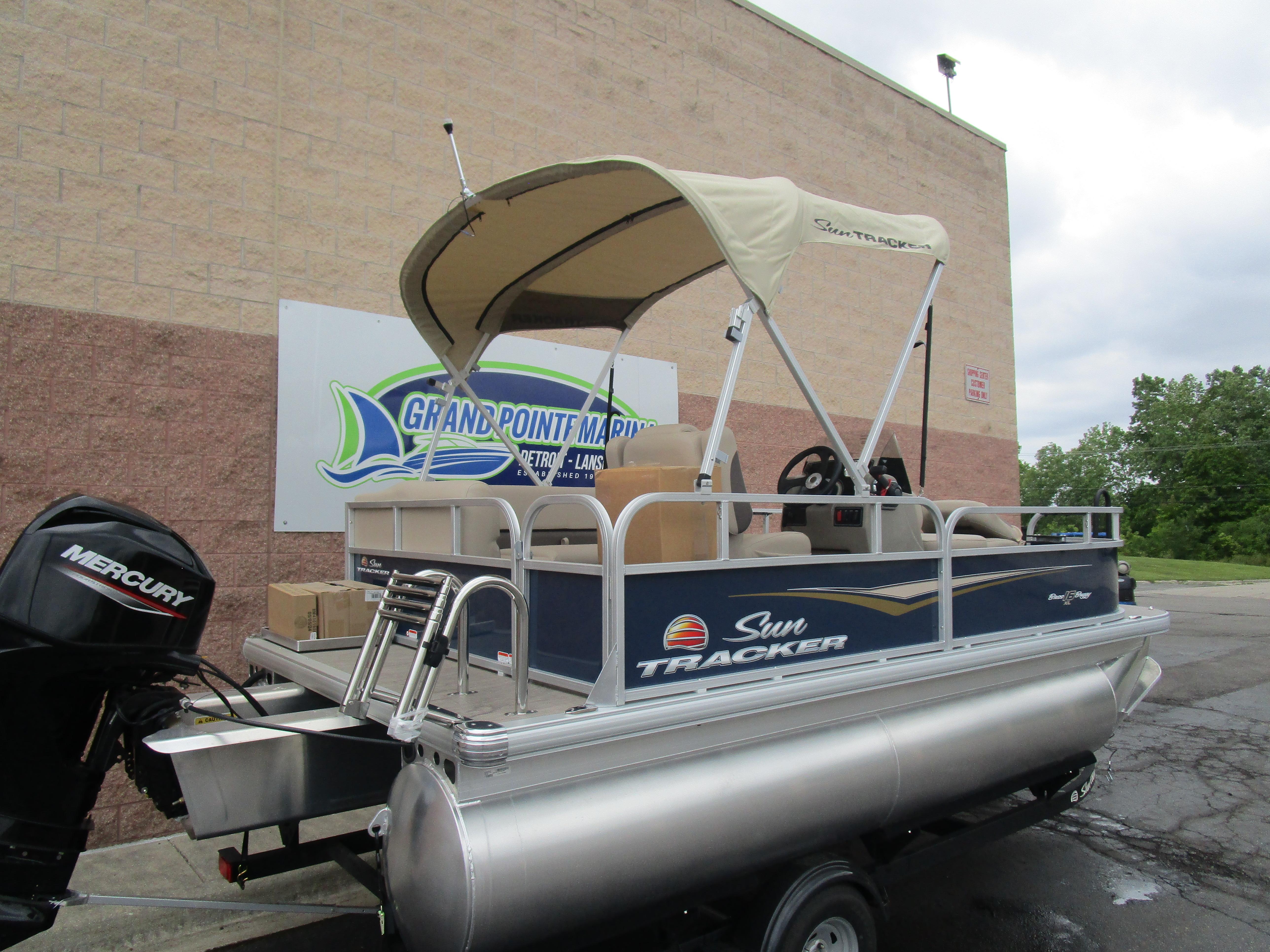 2025 Sun Tracker Bass Buggy 16 pontoon boat with canopy and Mercury engine.