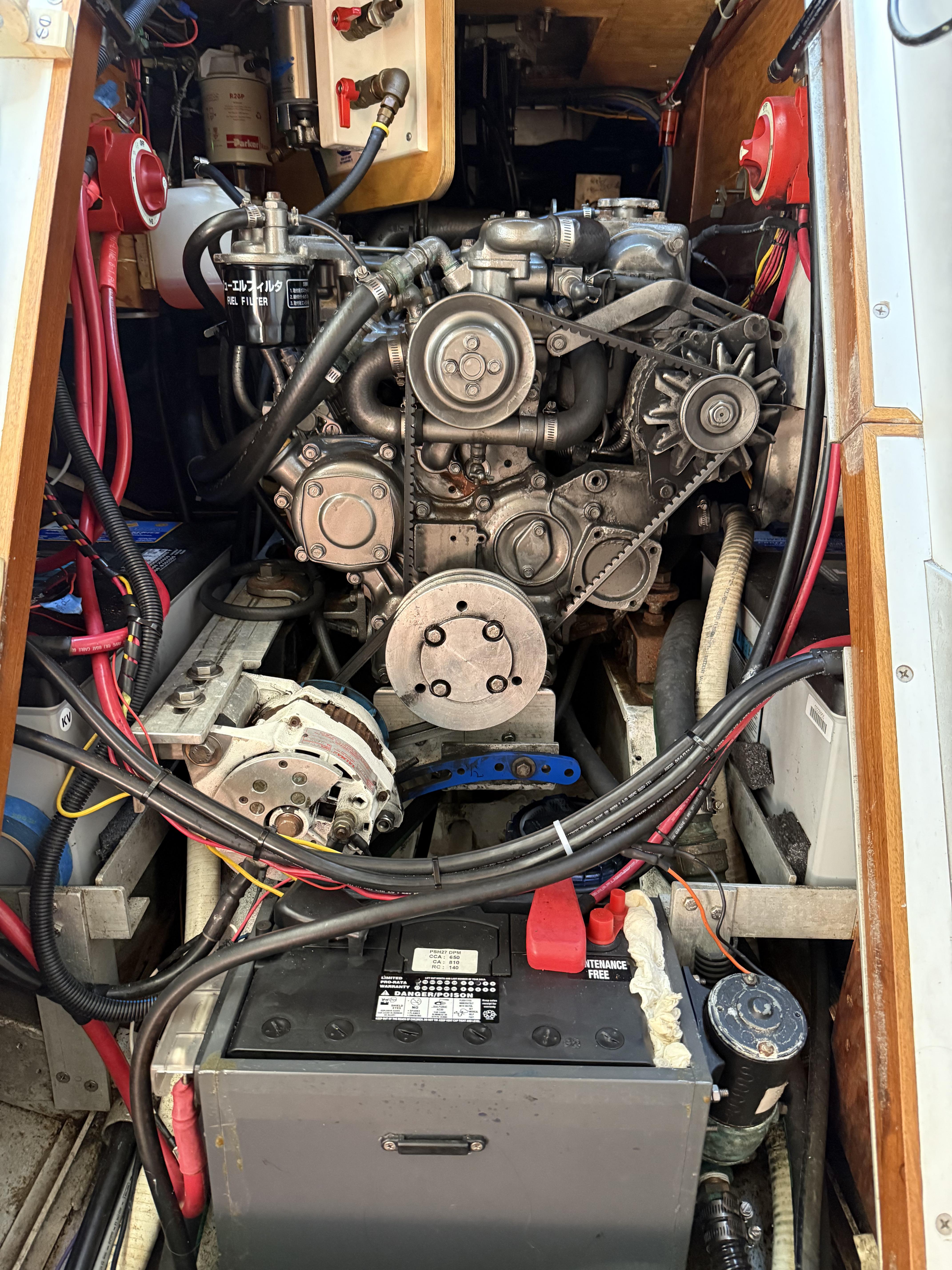 Engine compartment of a 1976 Frers Custom boat, showcasing mechanical components and wiring.