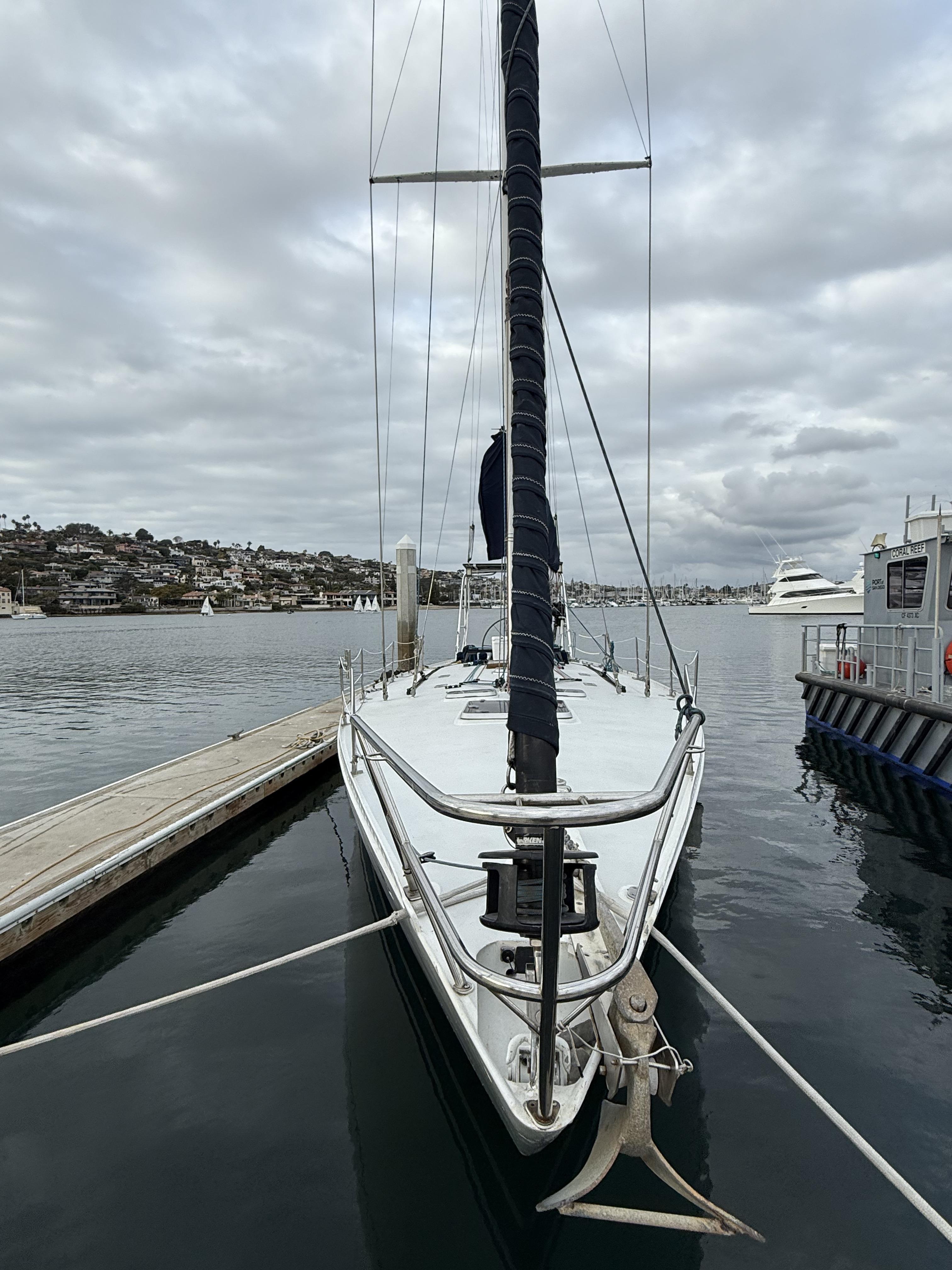 1976 Frers Custom sailboat docked in a marina under cloudy skies.