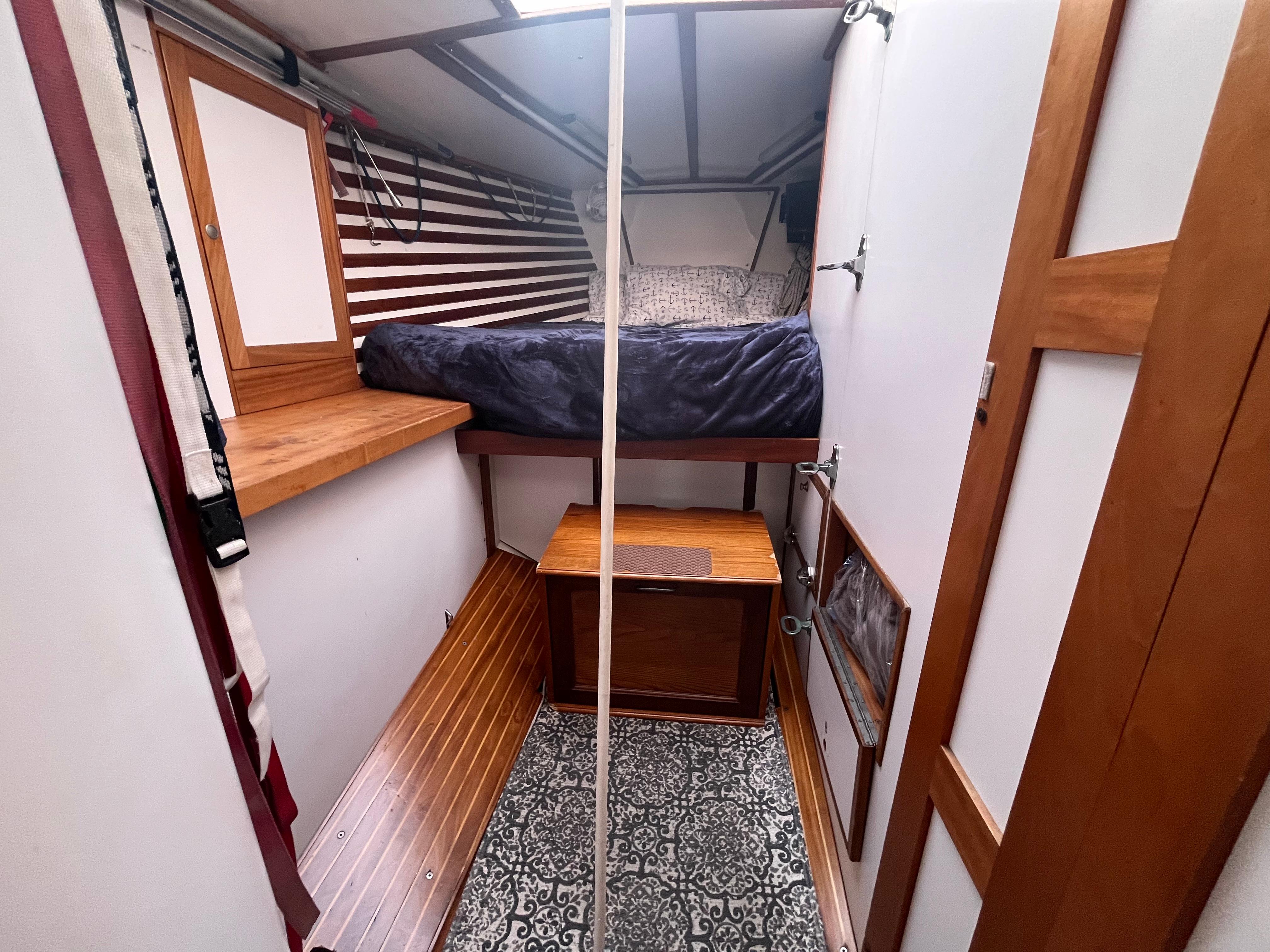 1976 Frers Custom yacht interior with wooden bunk bed and patterned flooring.