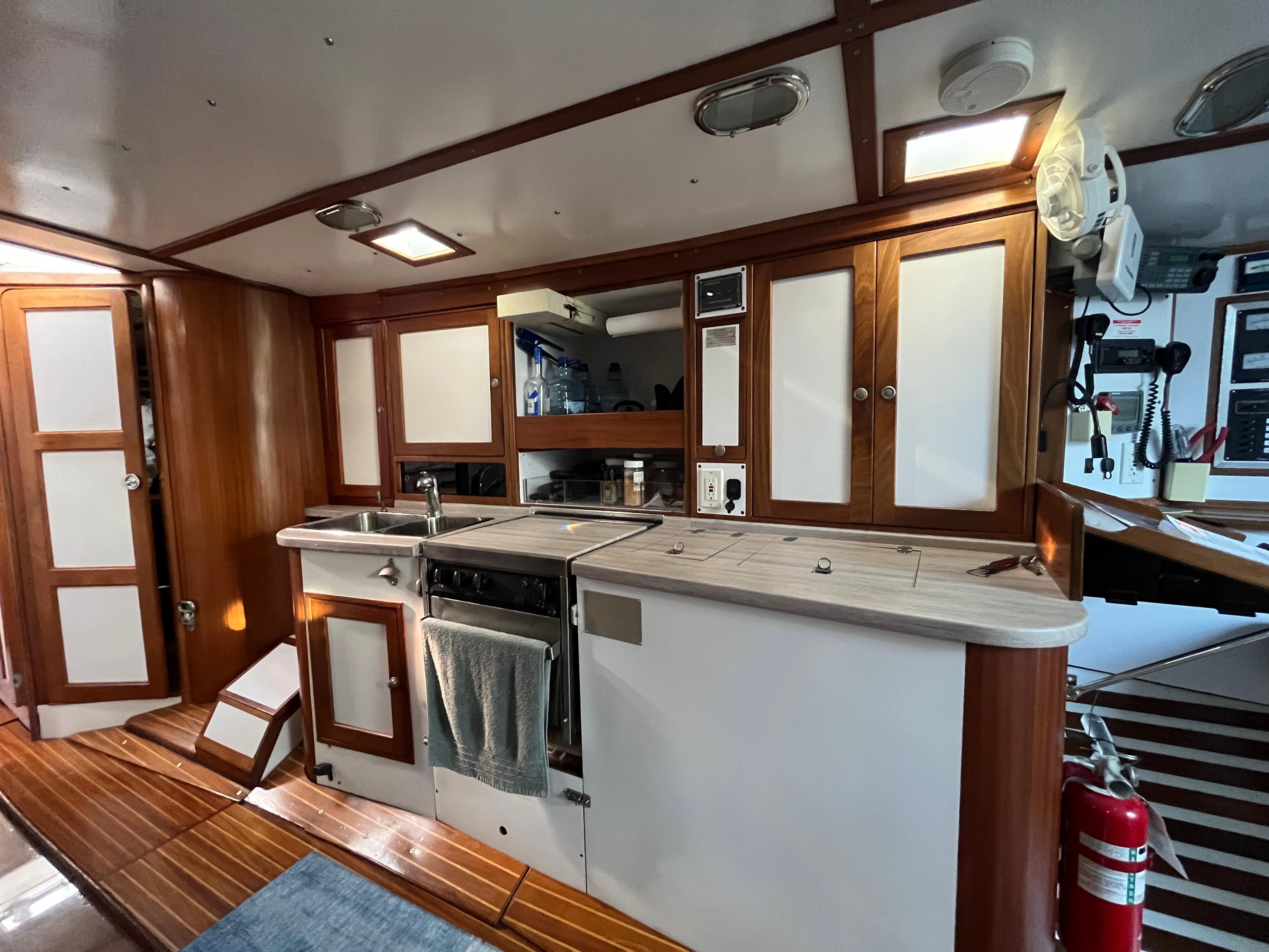 Interior of 1976 Frers Custom yacht featuring a modern kitchen with wooden cabinetry.