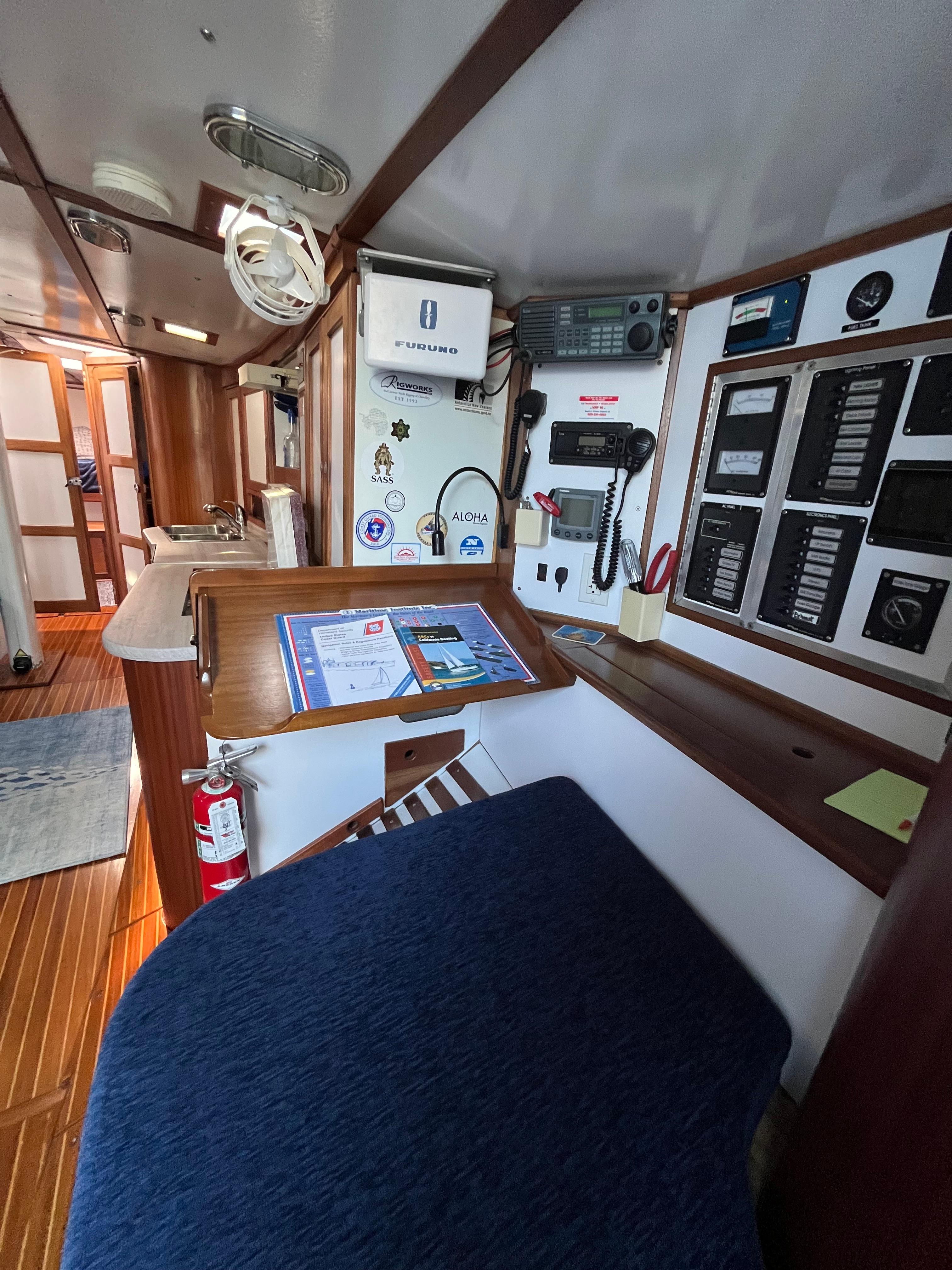 Interior of a 1976 Frers Custom yacht with navigation equipment and wooden finishes.