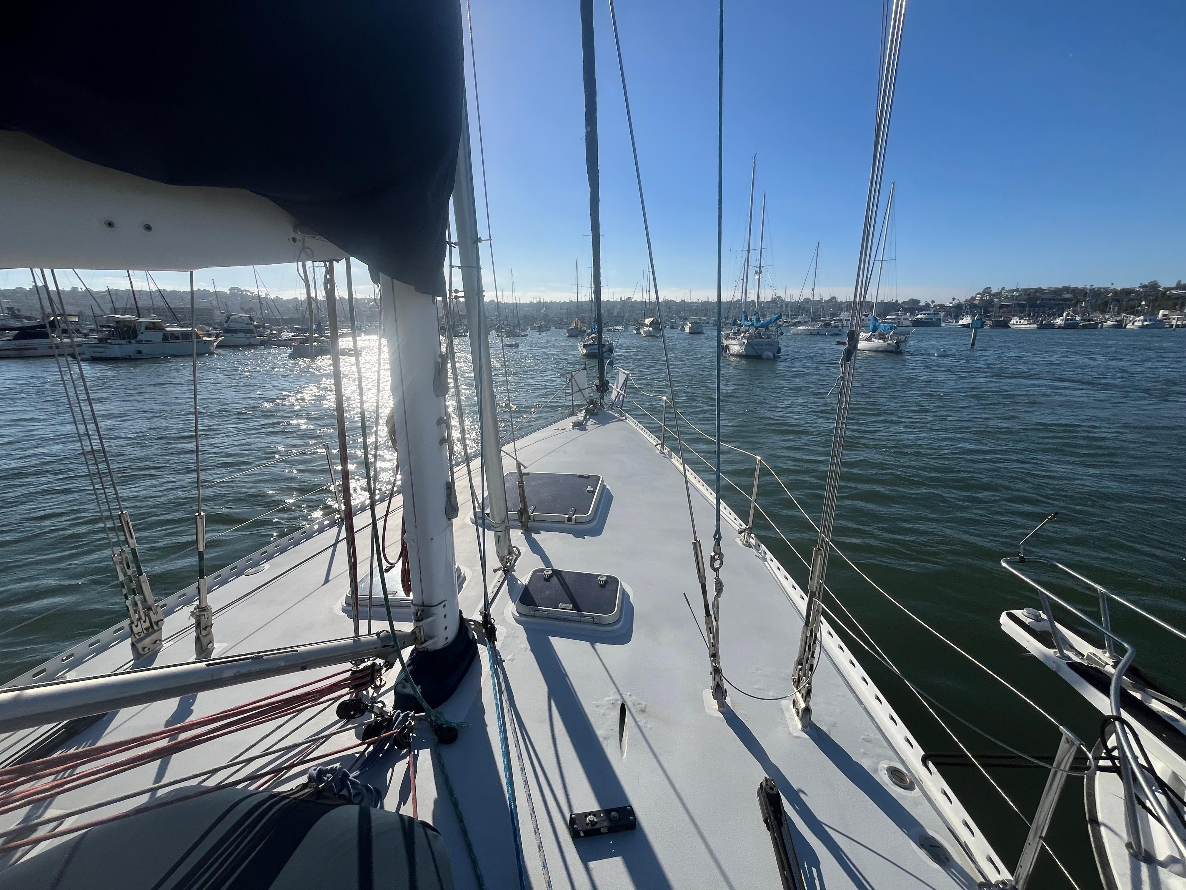 Sailing yacht Frers Custom 1976 on calm waters with clear blue sky.
