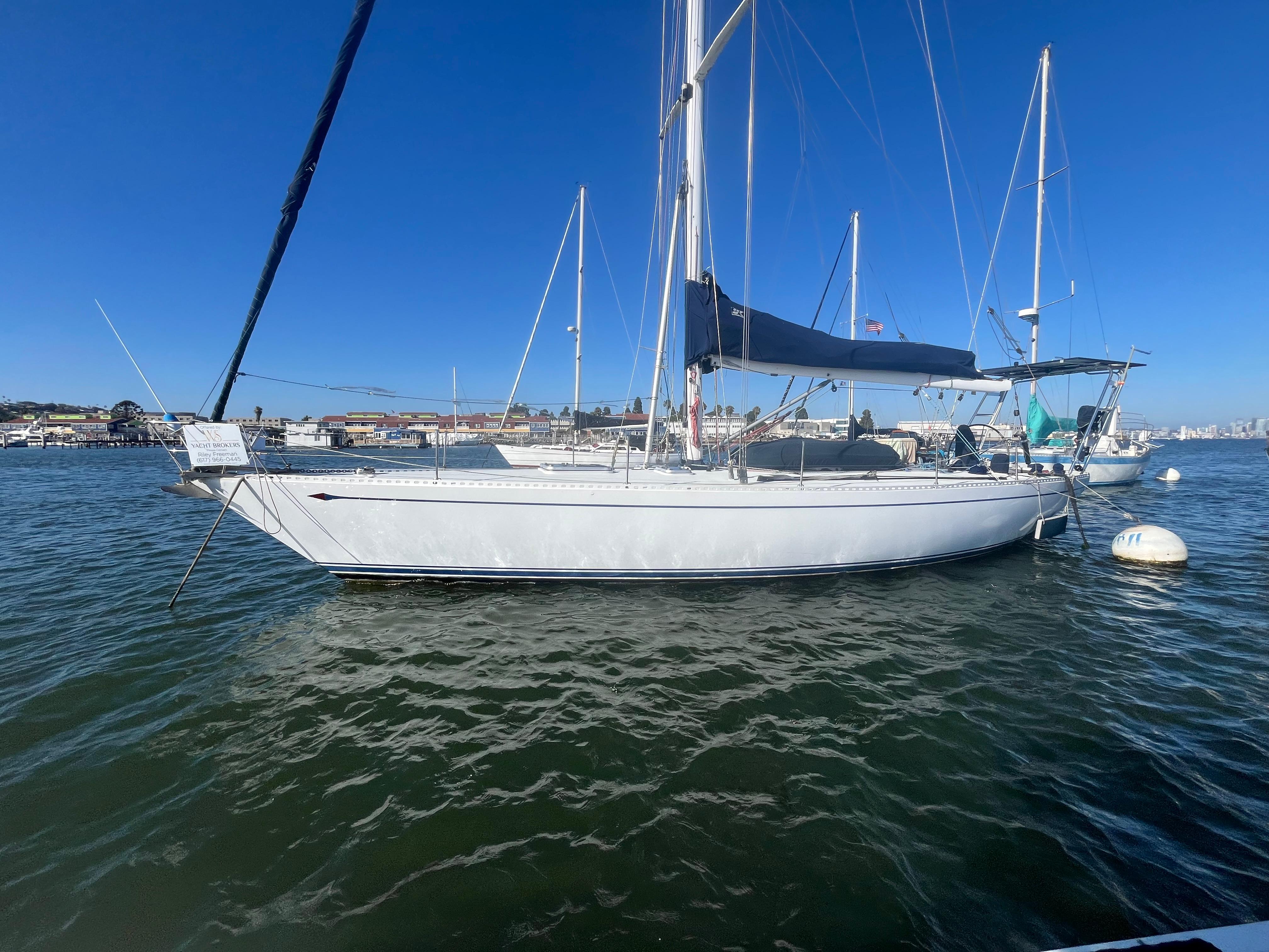 1976 Frers Custom sailboat docked in a marina under clear blue skies.