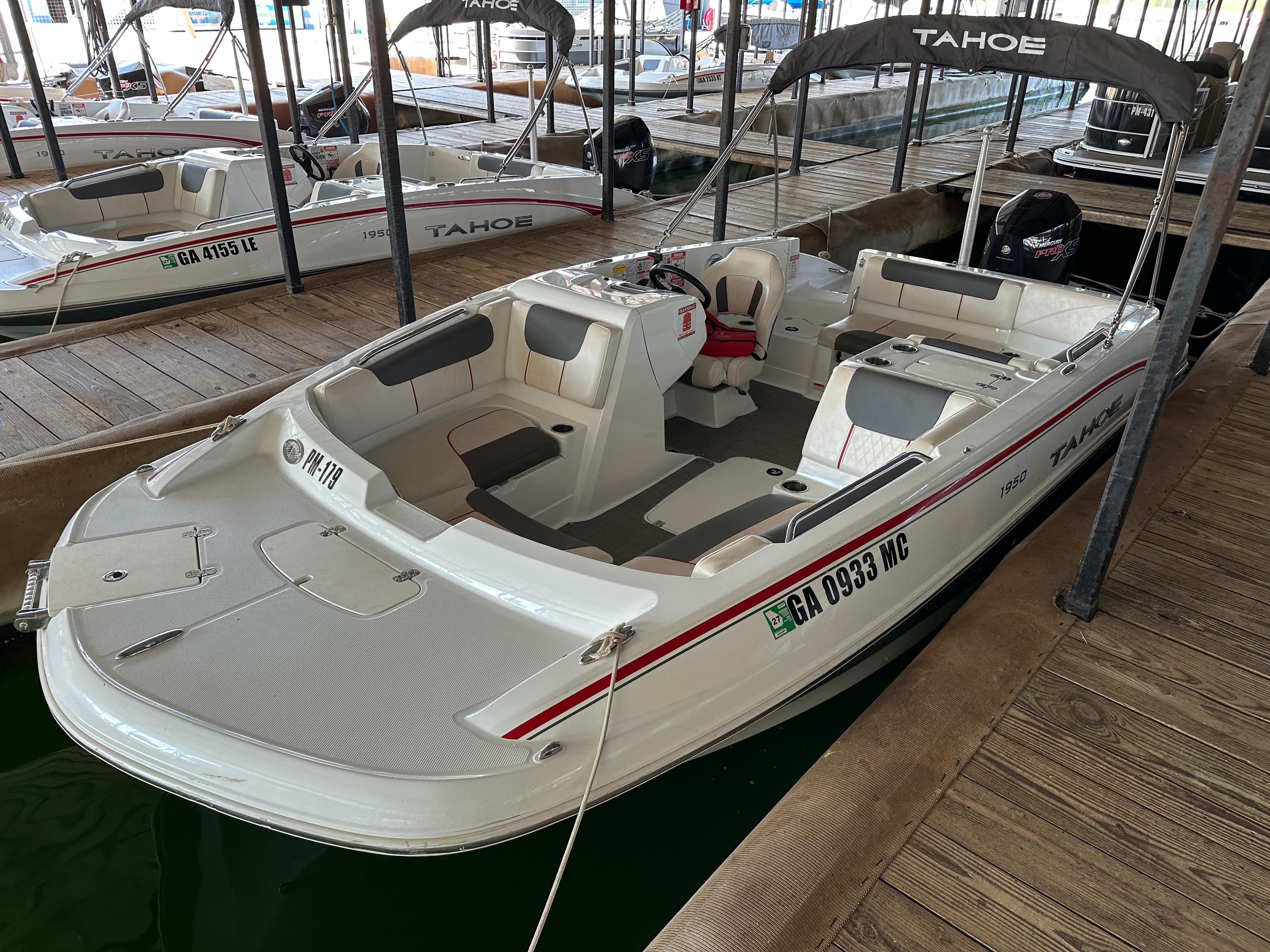2021 Tahoe 1950 boat docked, featuring spacious seating and sleek design.
