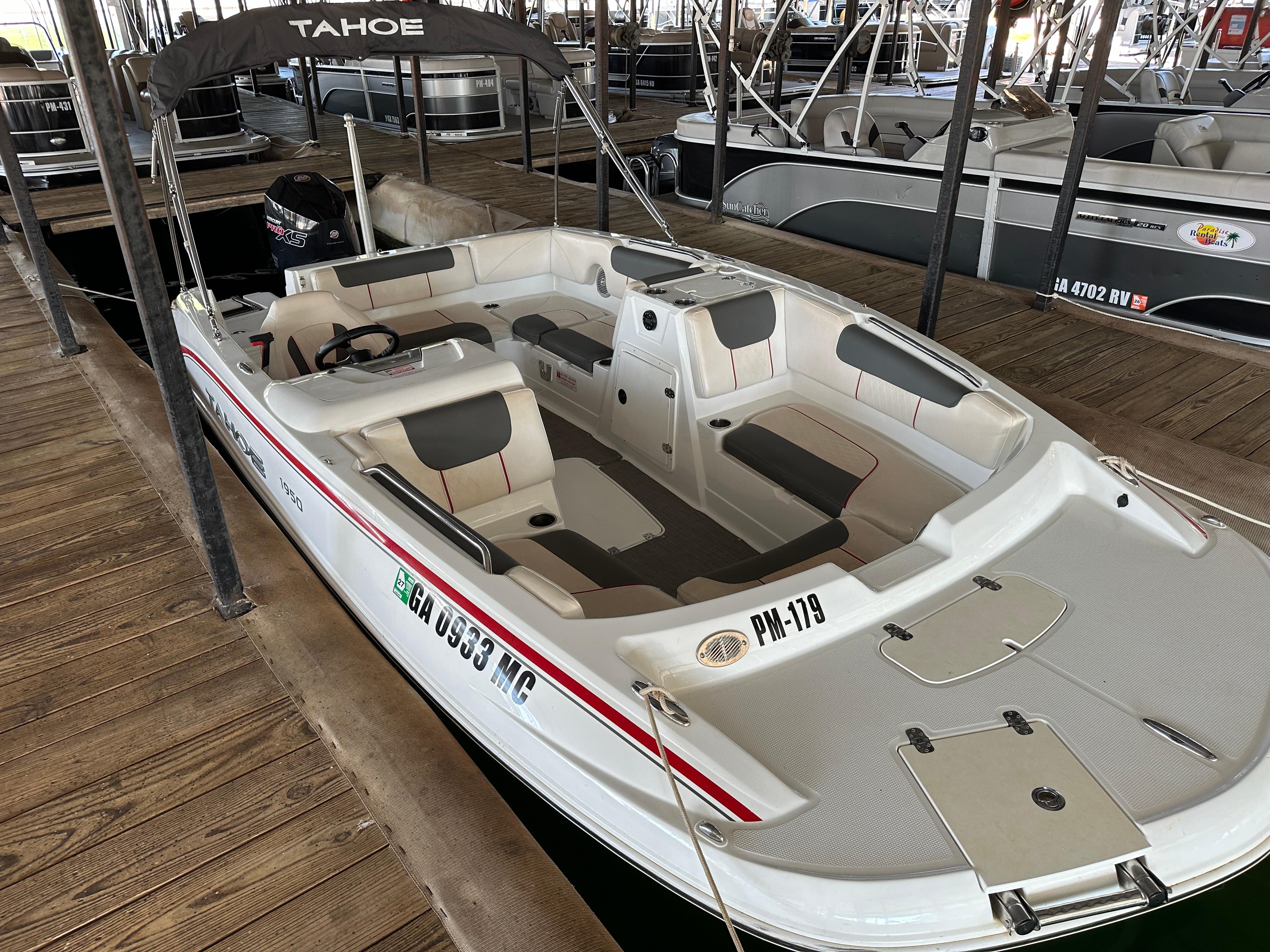 2021 Tahoe 1950 boat docked, featuring spacious seating and sleek design.