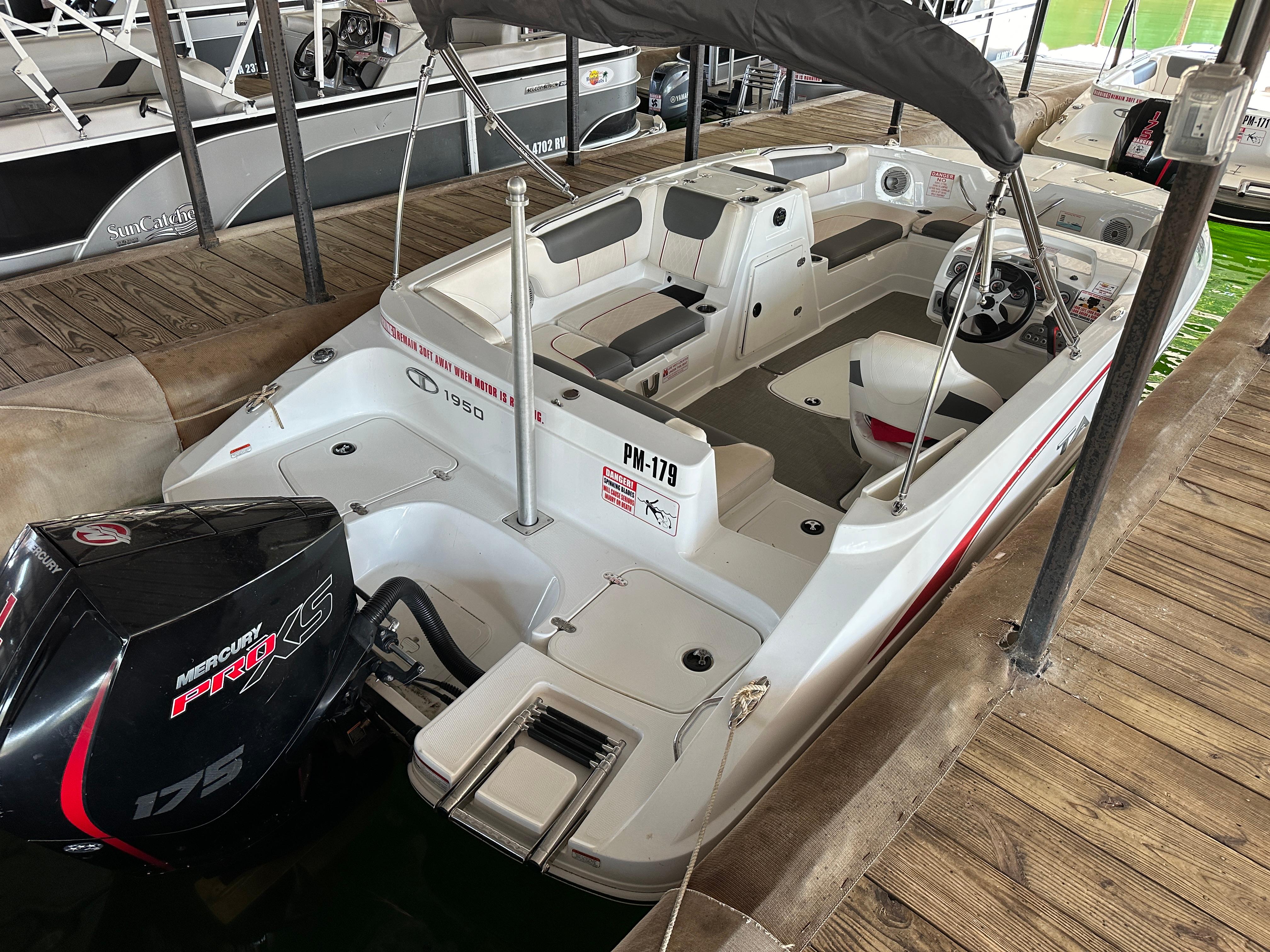 2021 Tahoe 1950 boat with Mercury Pro XS 175 engine docked at marina.