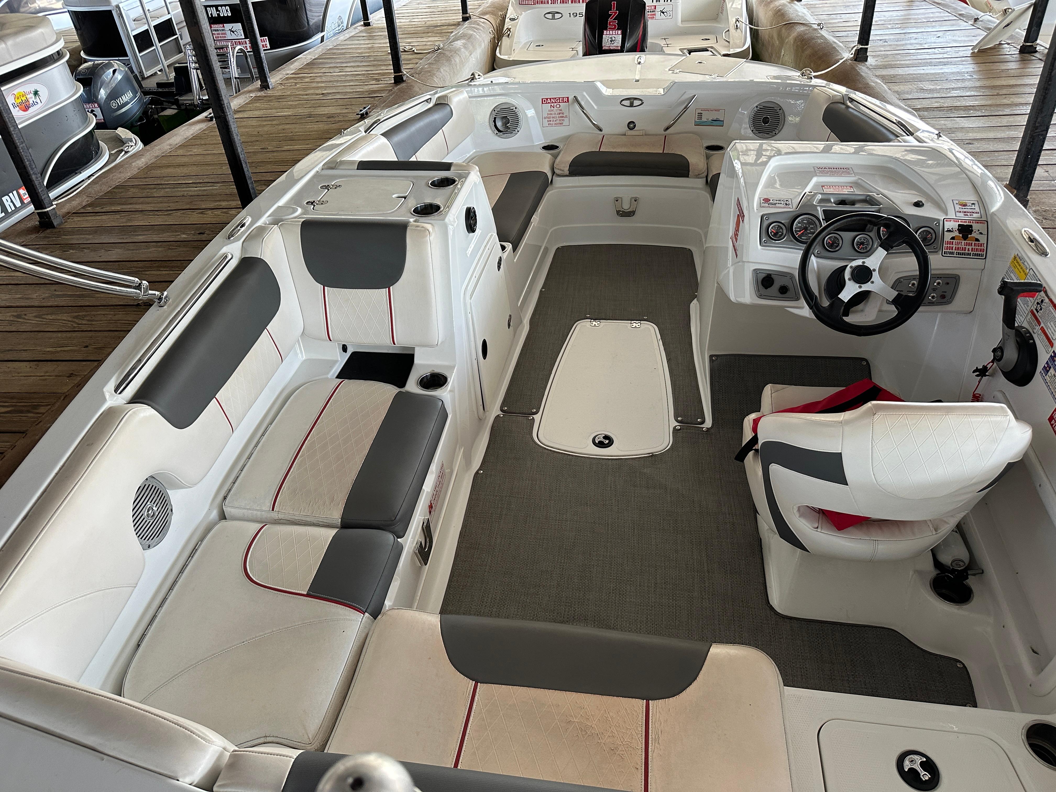 Interior of a 2021 Tahoe 1950 boat with seating and steering wheel.