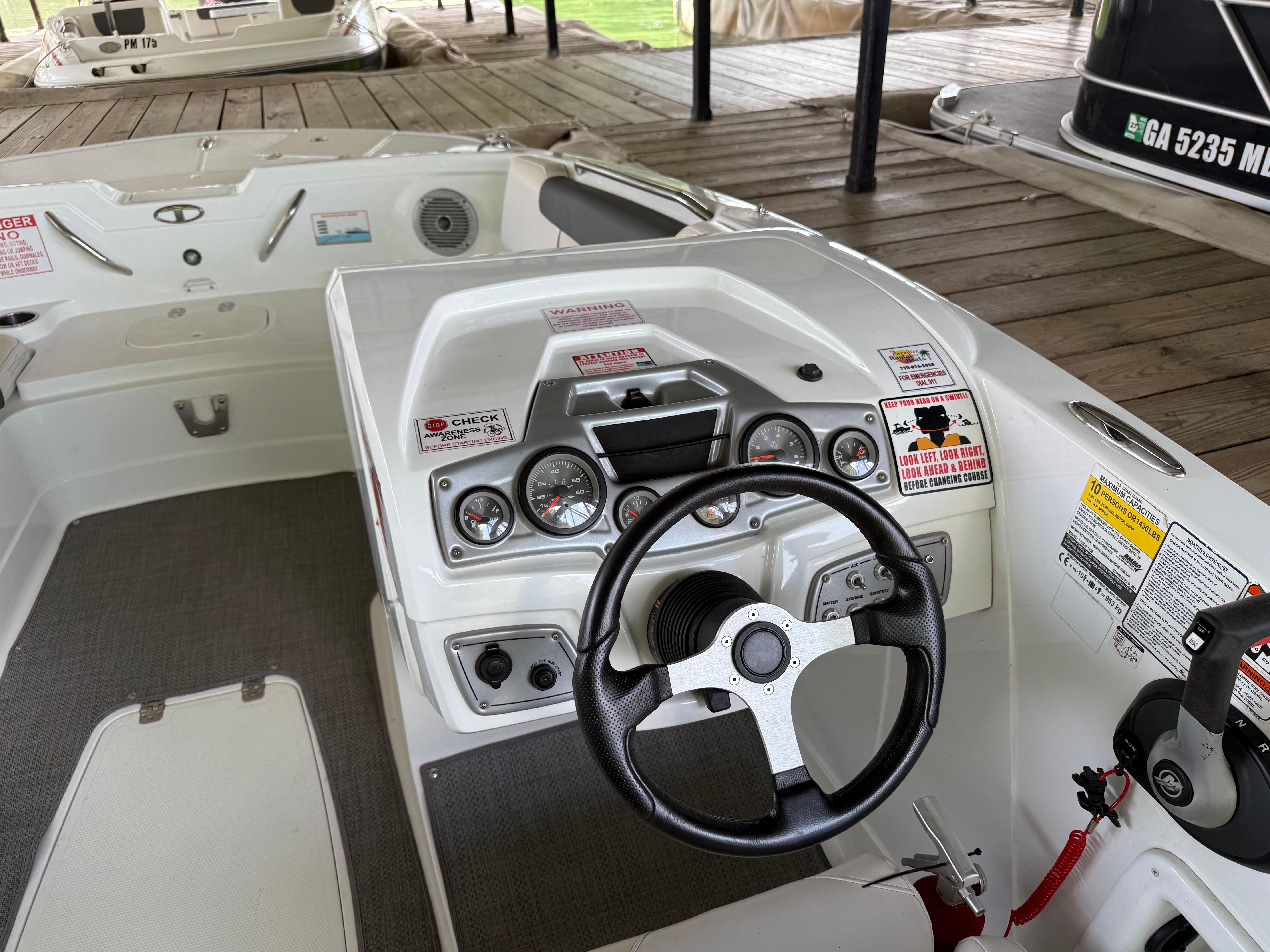 Steering console of a 2021 Tahoe 1950 boat with gauges and controls.