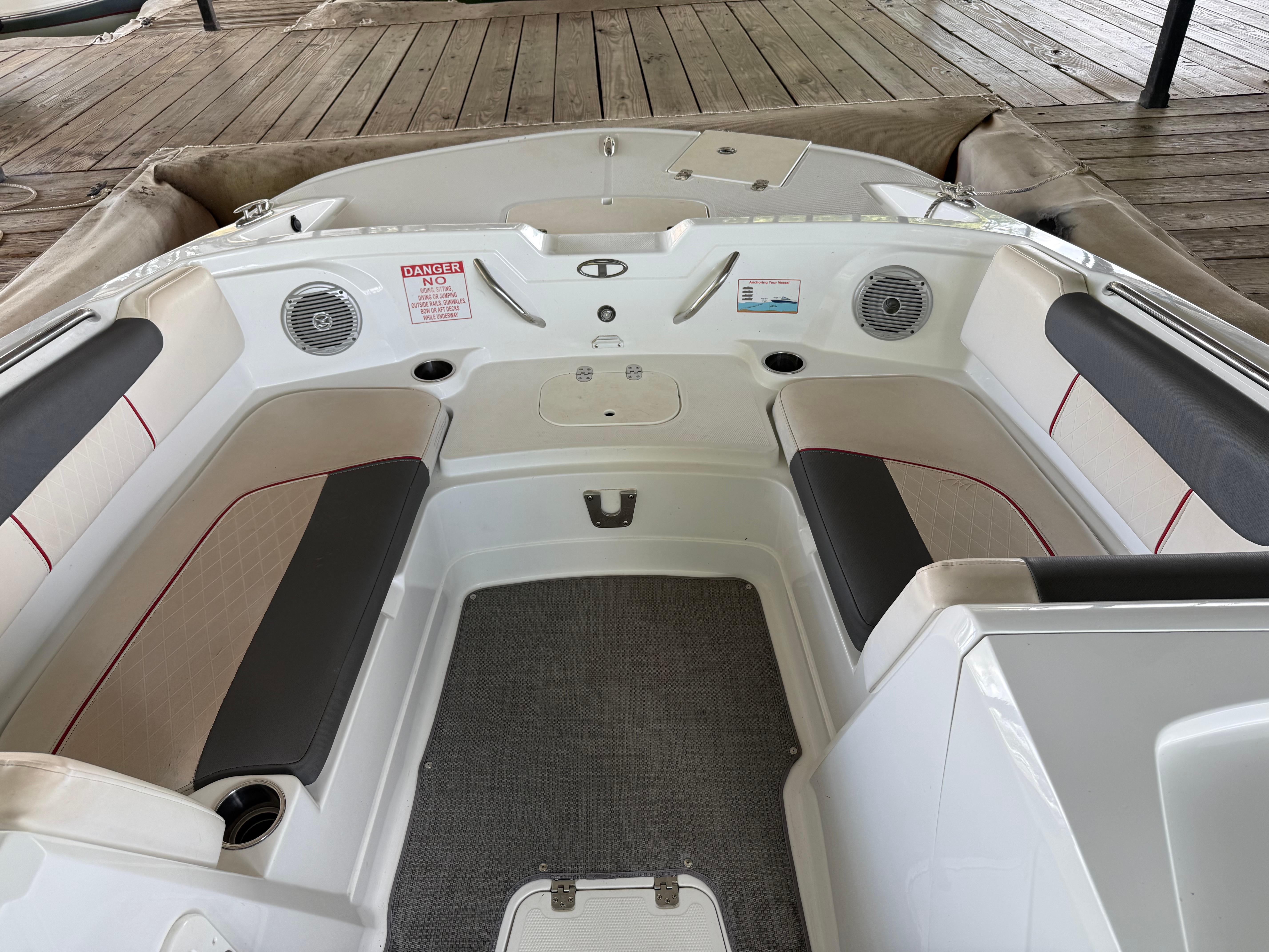 Interior of a 2021 Tahoe 1950 boat with cushioned seating and speakers.