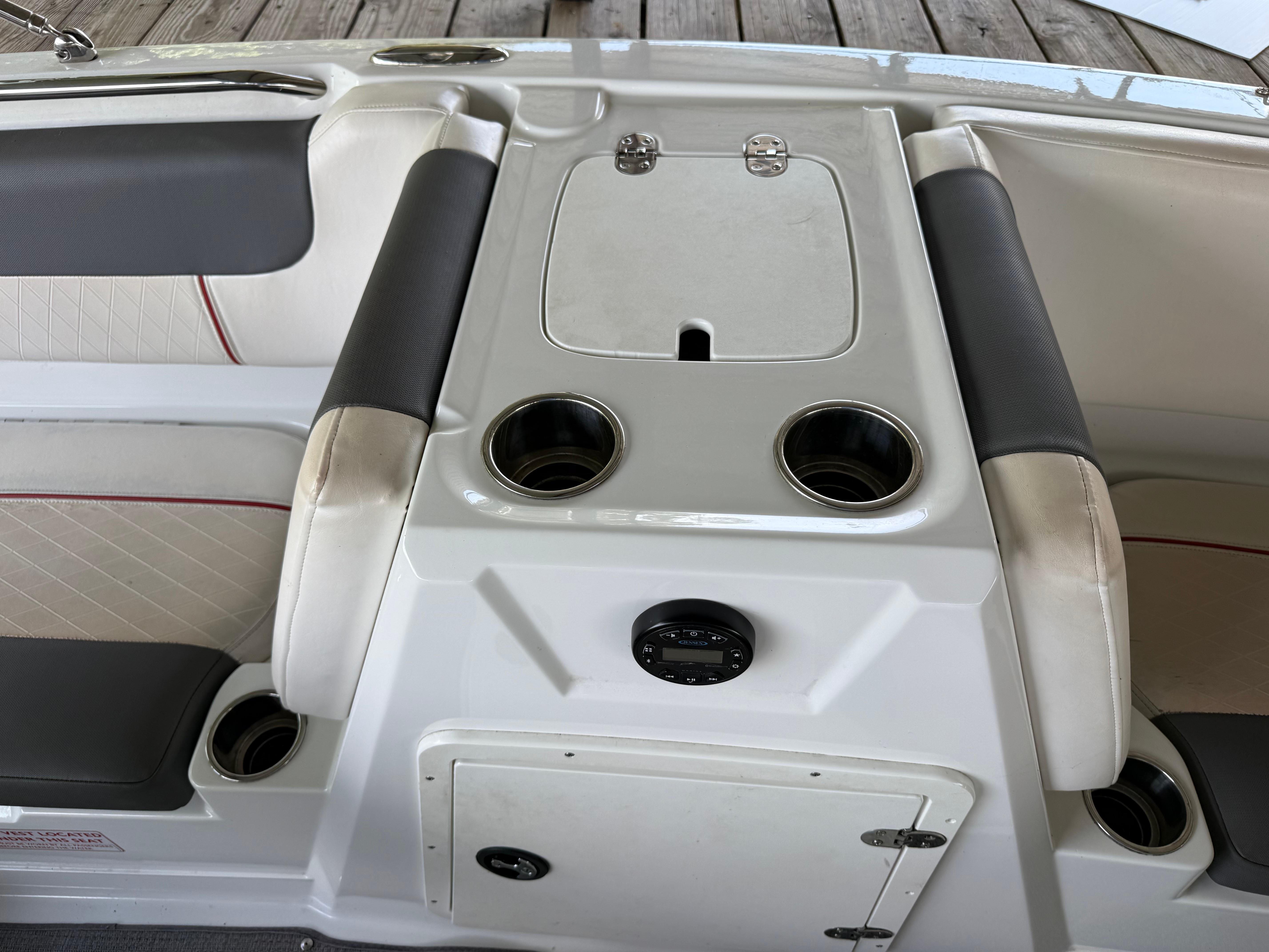 Interior of a 2021 Tahoe 1950 boat with cup holders and storage compartment.