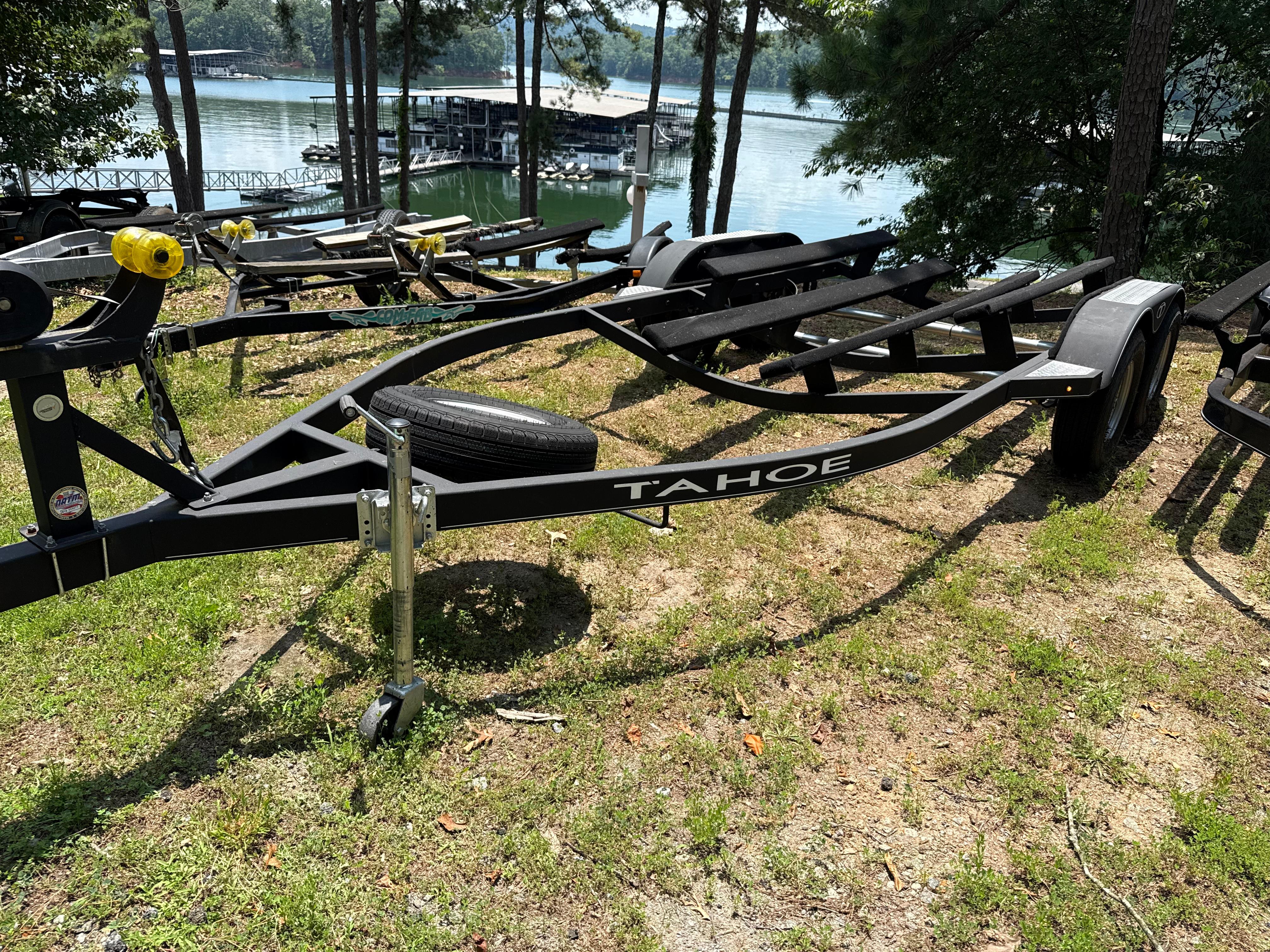 Boat trailer by Tahoe, model 1950, 2021, near a scenic lake.