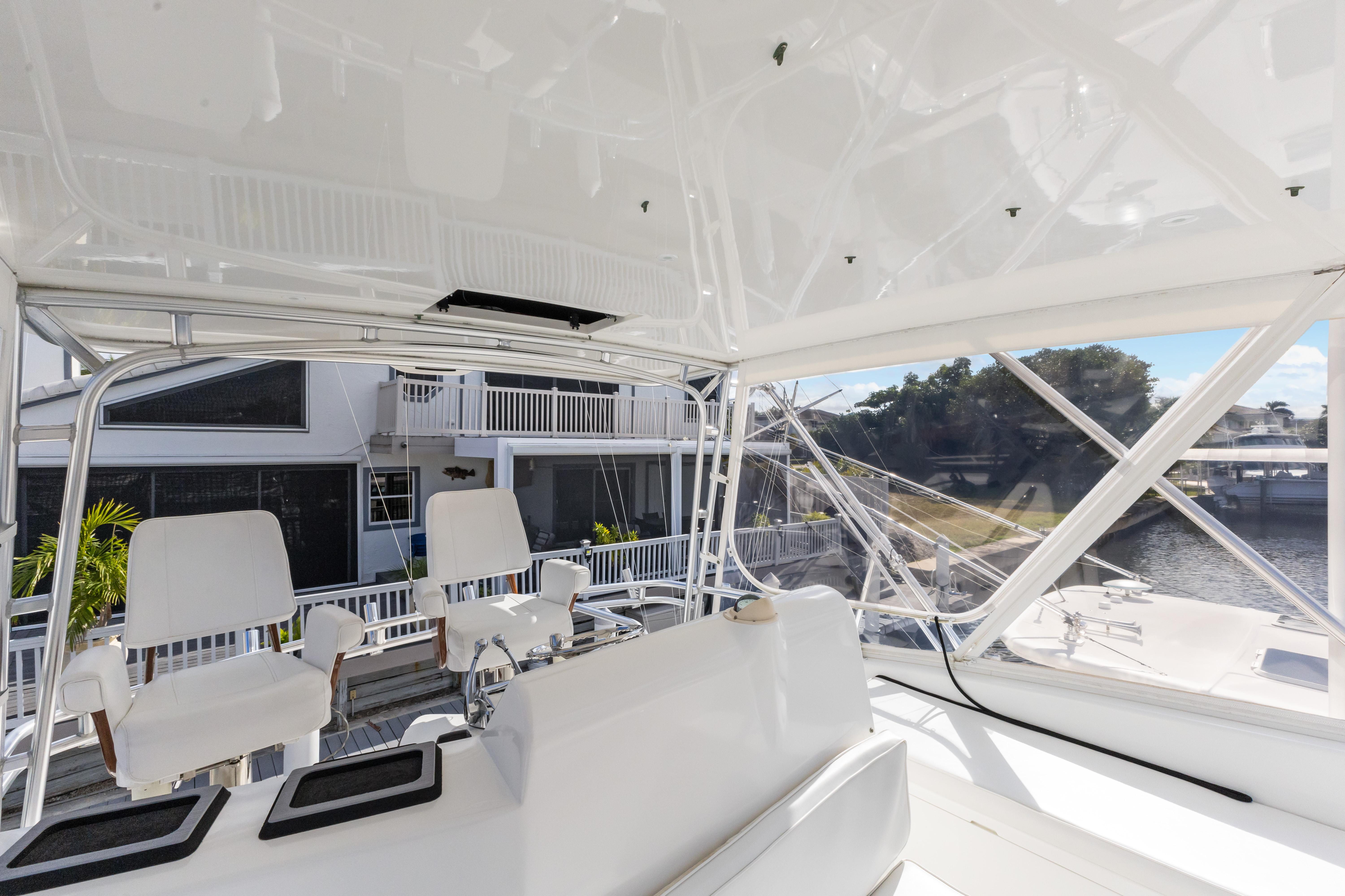 Cabo-40 Flybridge 2011-WELL PLAYED FL-US-2011 Cabo 40 Flybridge interior with white seating and marina view.-9659613 | Thumbnail
