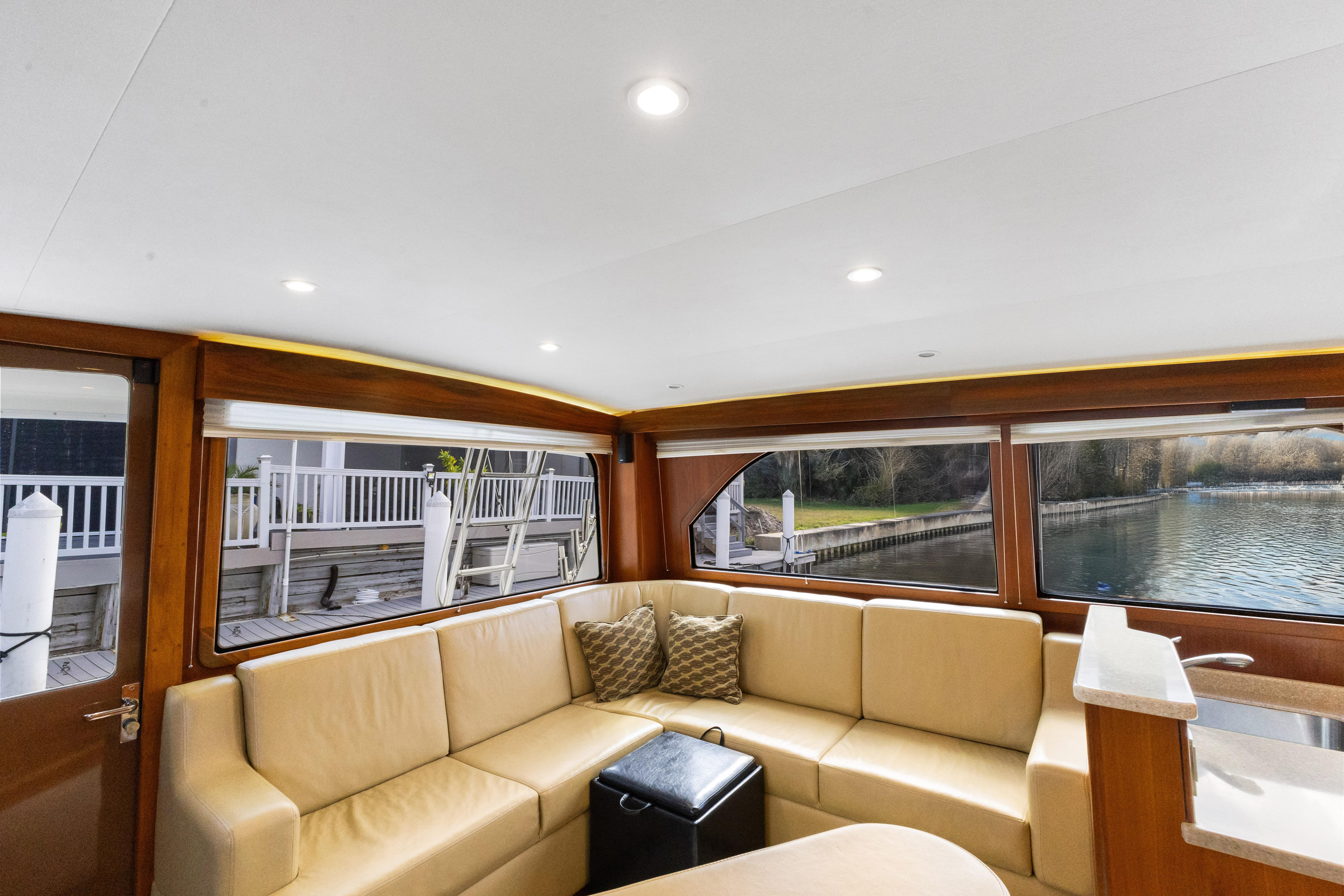 Cabo-40 Flybridge 2011-WELL PLAYED FL-US-Luxurious interior of 2011 Cabo 40 Flybridge yacht with beige seating and waterfront view.-9659613 | Thumbnail
