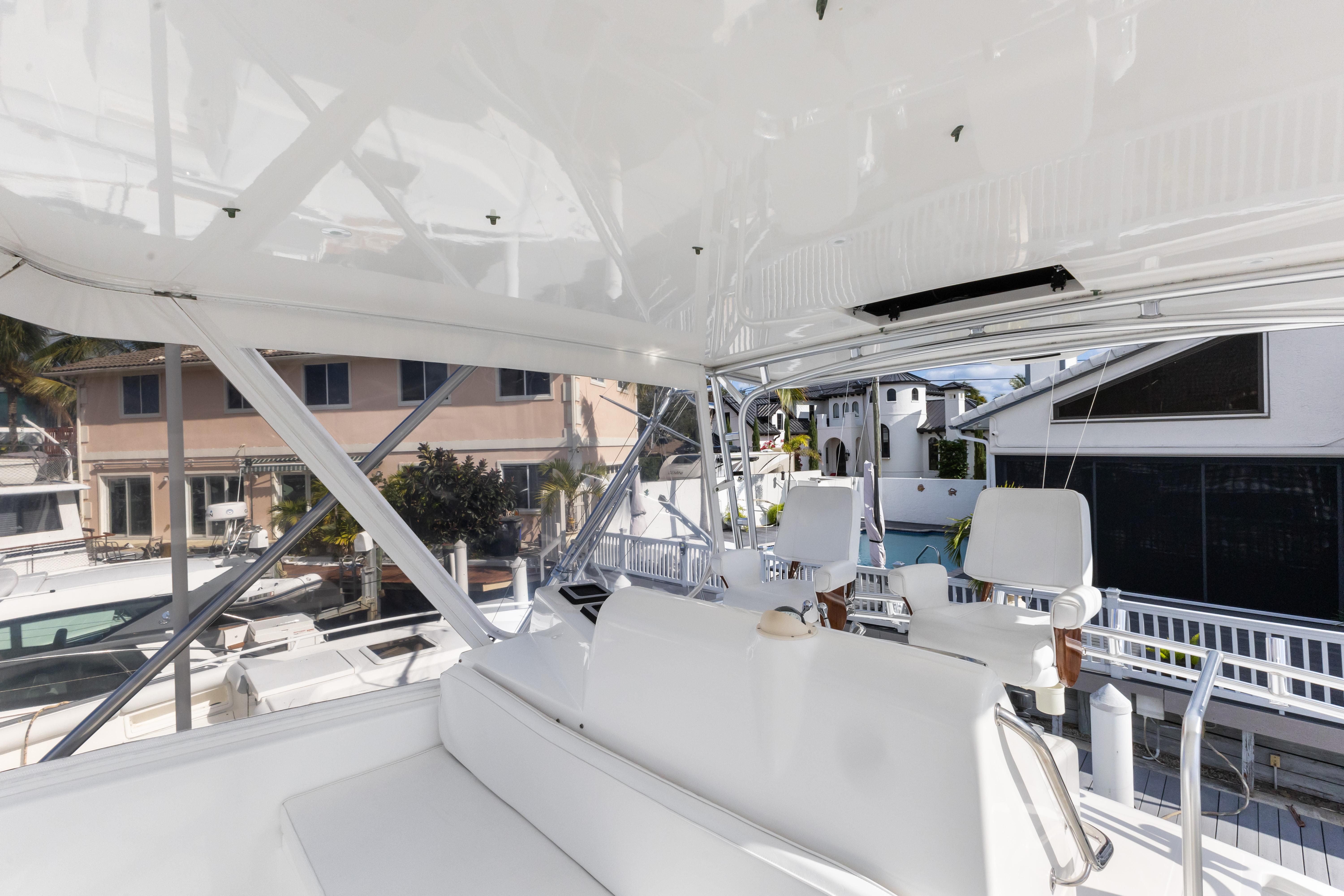 Cabo-40 Flybridge 2011-WELL PLAYED FL-US-Flybridge interior of 2011 Cabo 40, featuring white seating and marina view.-9659613 | Thumbnail